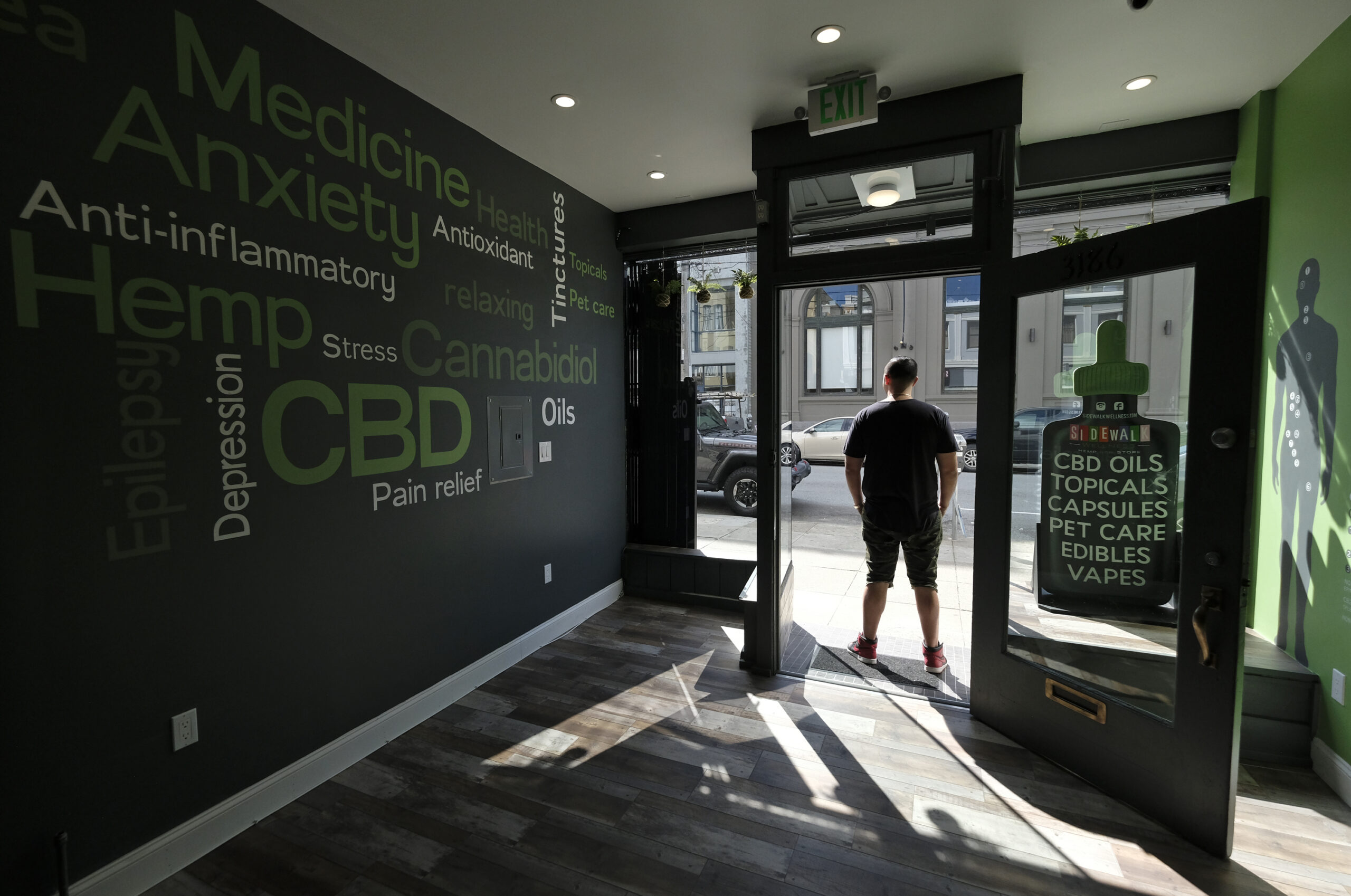Gus Dabais stands in his CBD shop