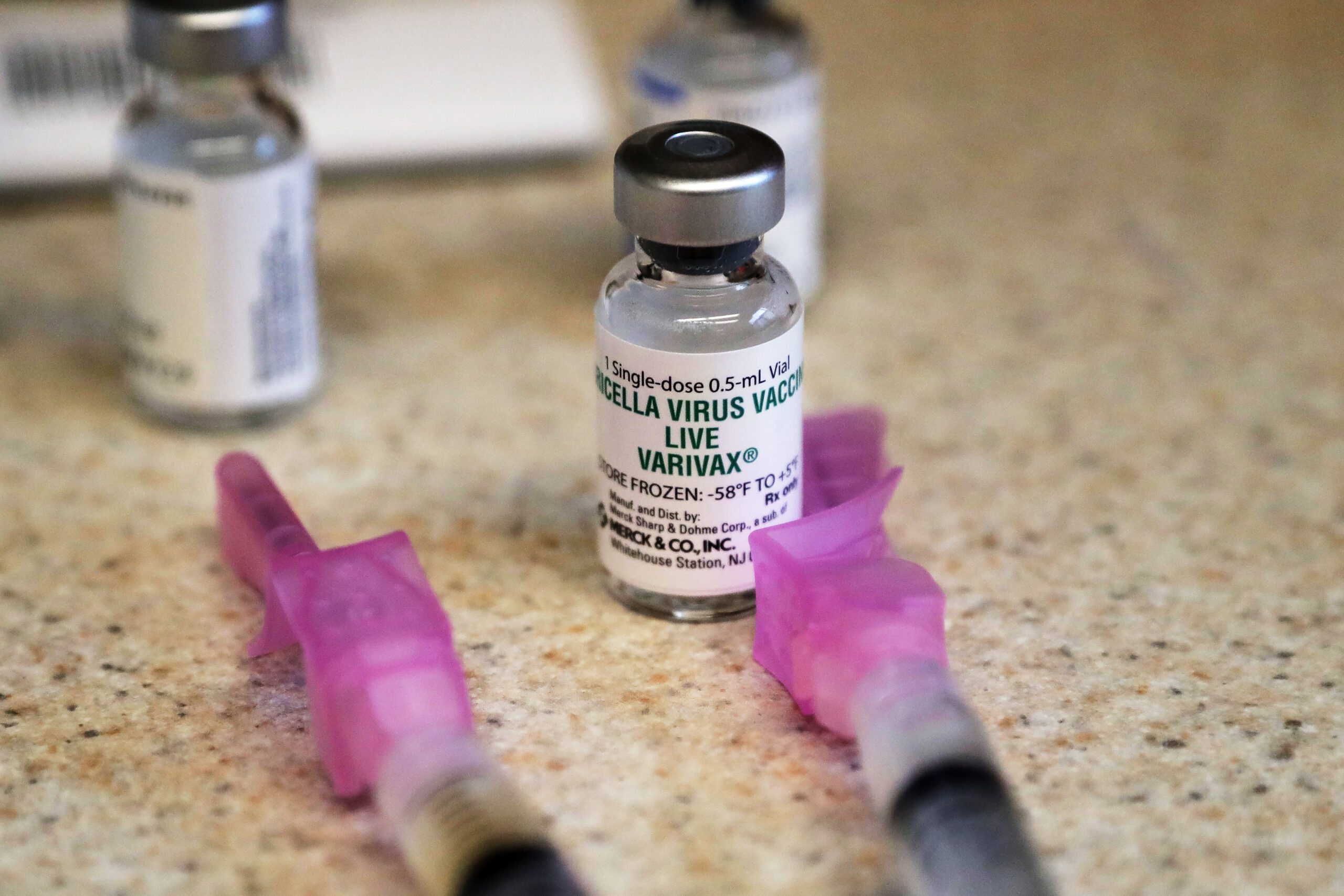 A chickenpox vaccine sits next to syringes