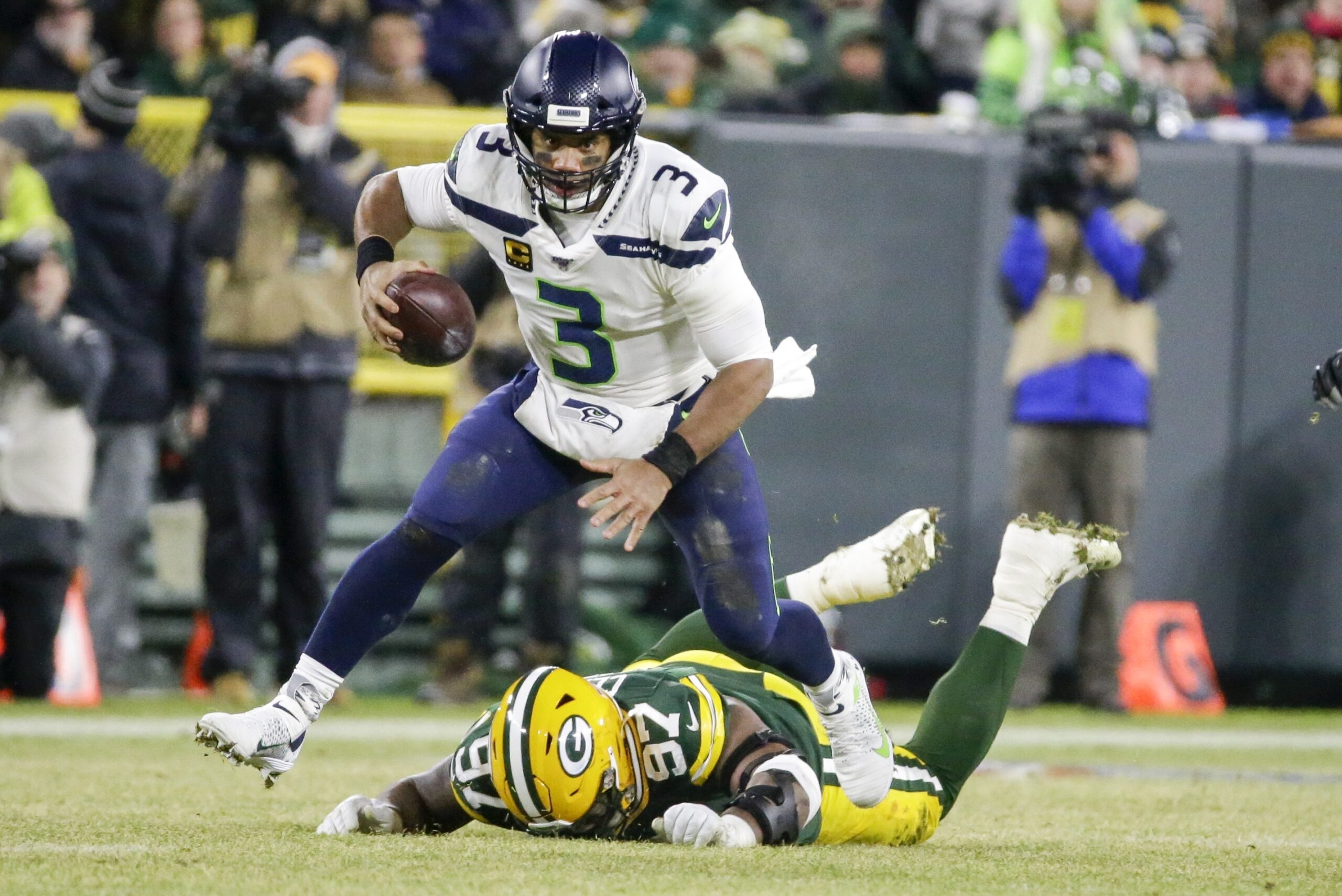 Seattle Seahawks quarterback Russell Wilson makes a play in an NFL playoff game
