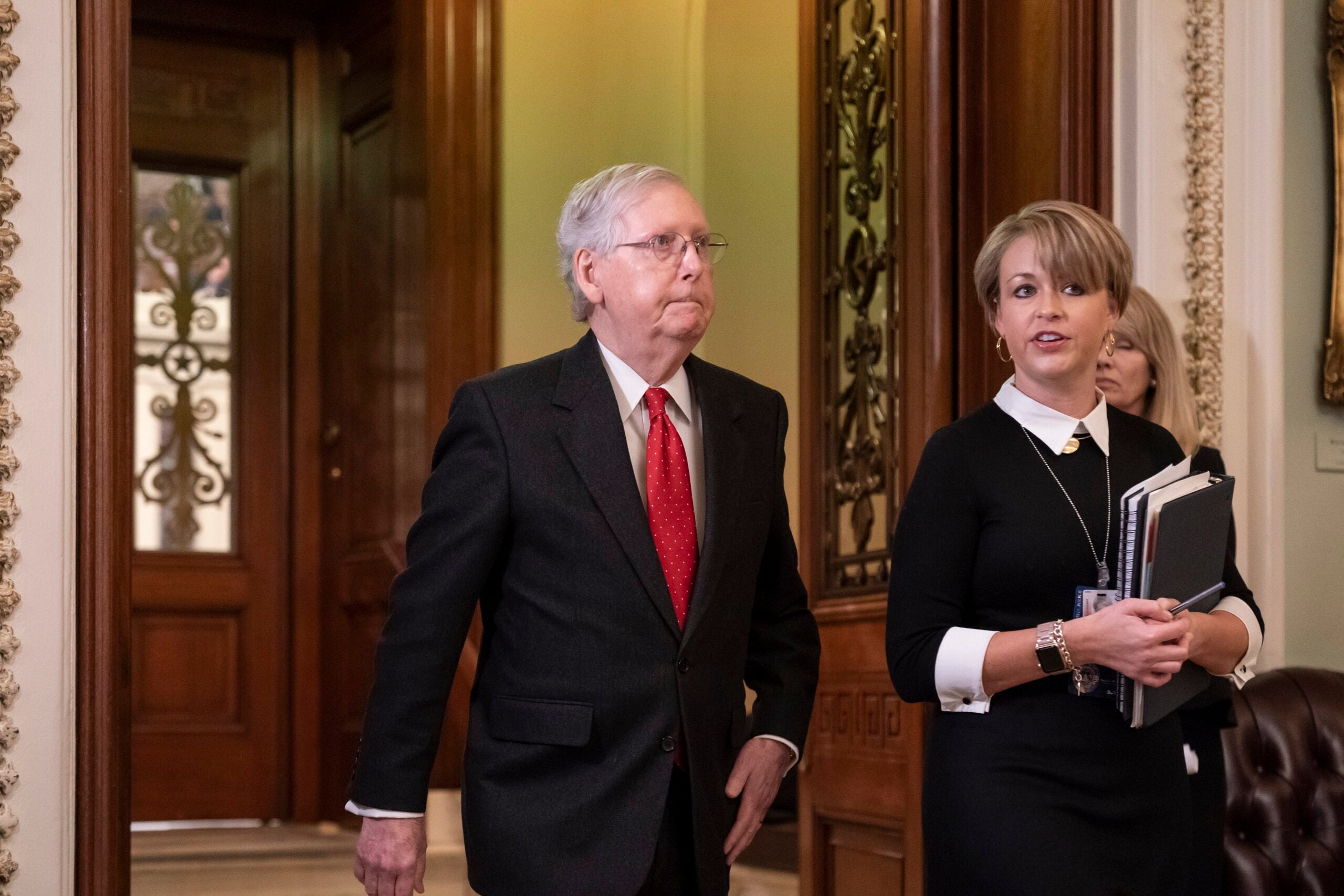 Senate Majority Leader Mitch McConnell, R-Ky., steps out of the chamber during the start of the impeachment trial of President Donald Trump