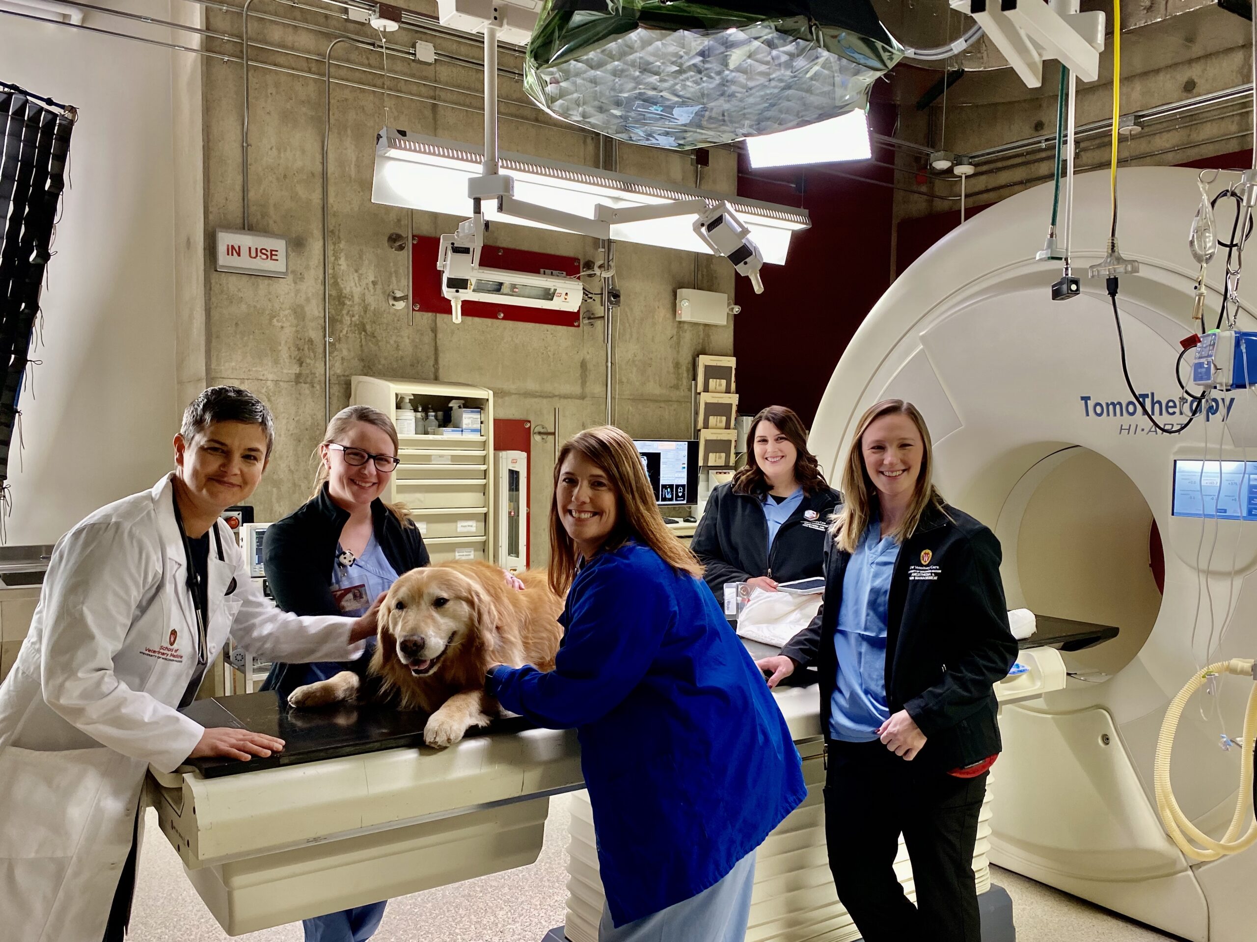 Scout poses with members of the UW Veterinary Care’s team