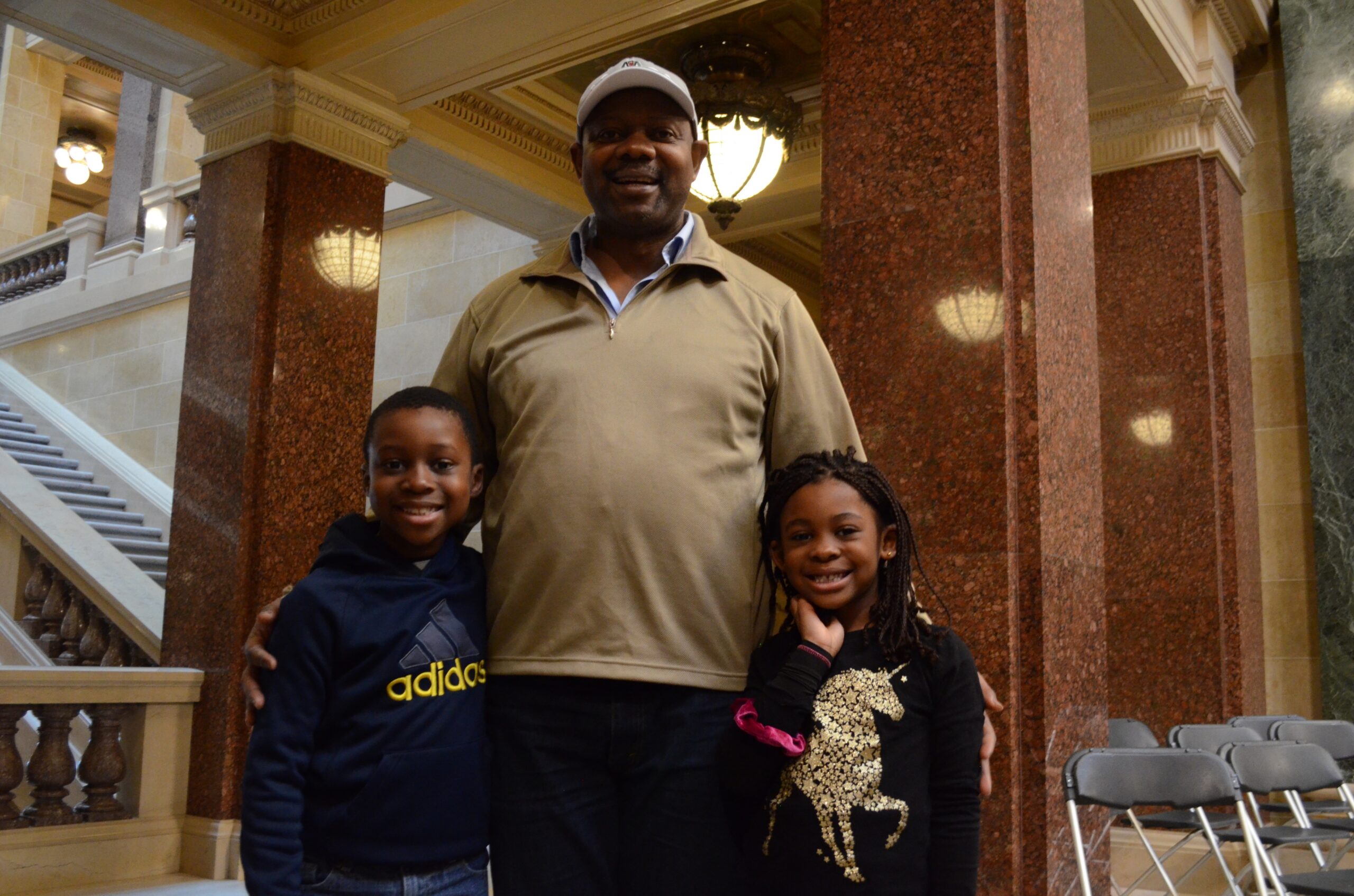 Jean-René Watchou stands with his children, Kenzo-Samuel, 8 years old, and Leá-Rosalie, 5-and-a-half years old.