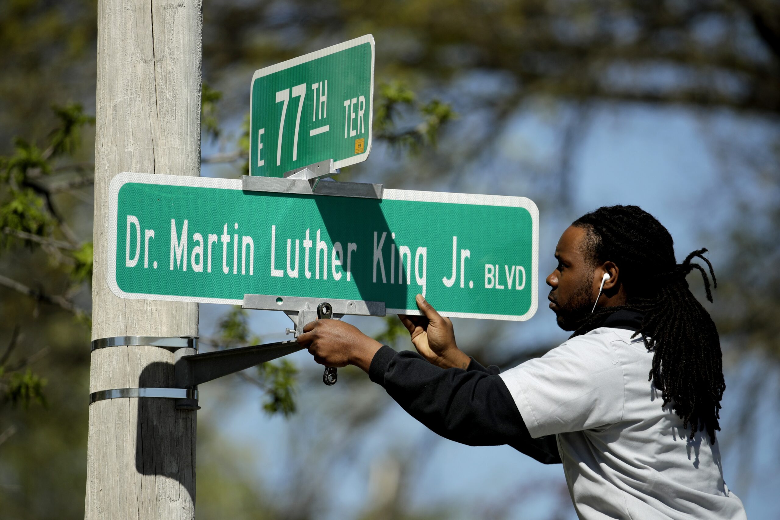person changes a street sign to Dr. Martin Luther King, Jr. BLVD