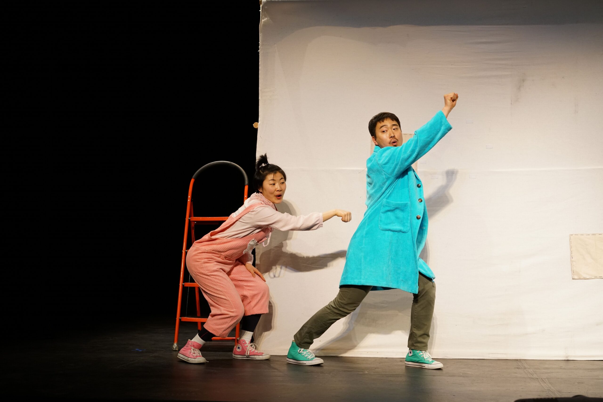 Two young actors performing on theater stage