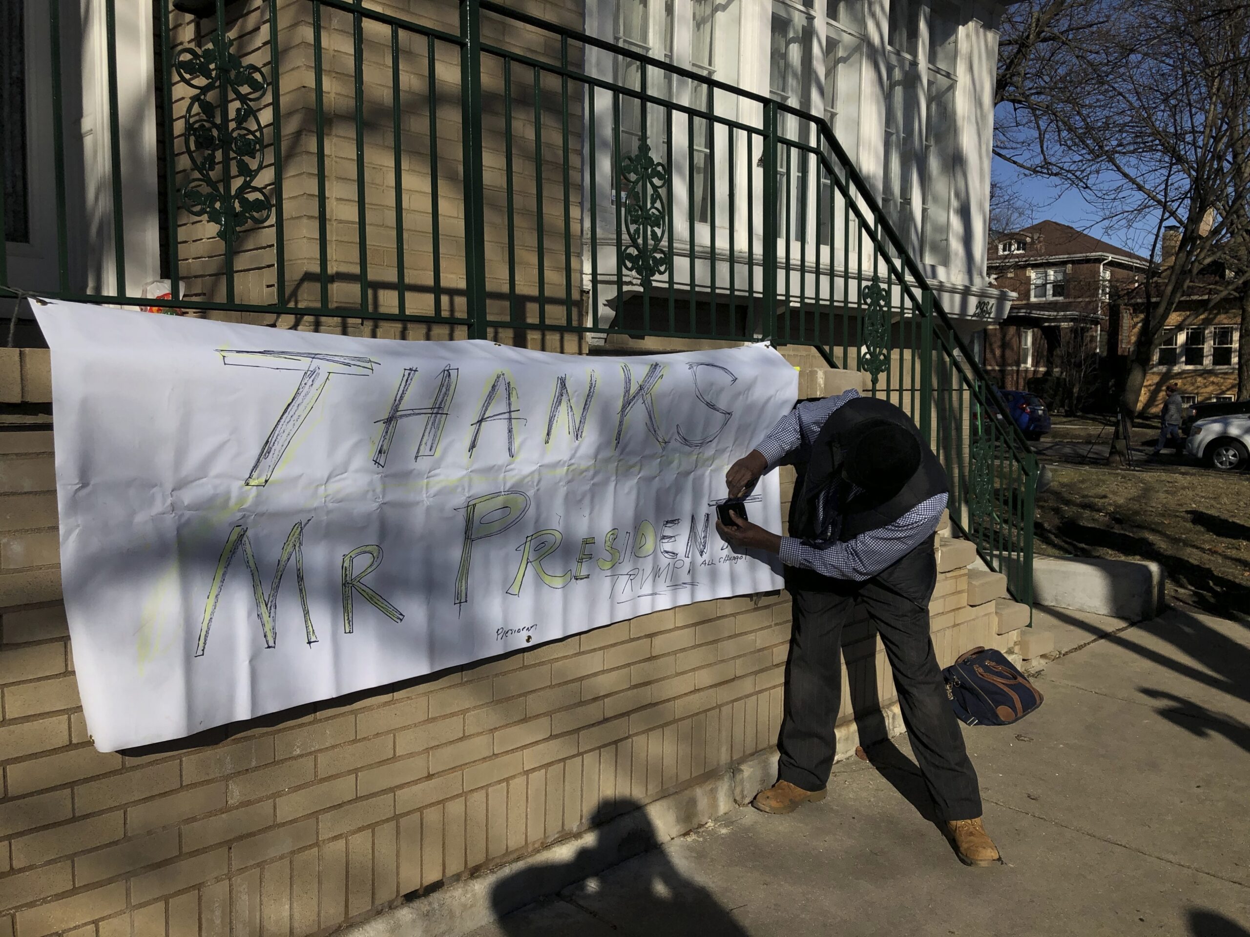 Ziff Sistrunk of Chicago places a sign of support in front of the home of Patti Blagojevich