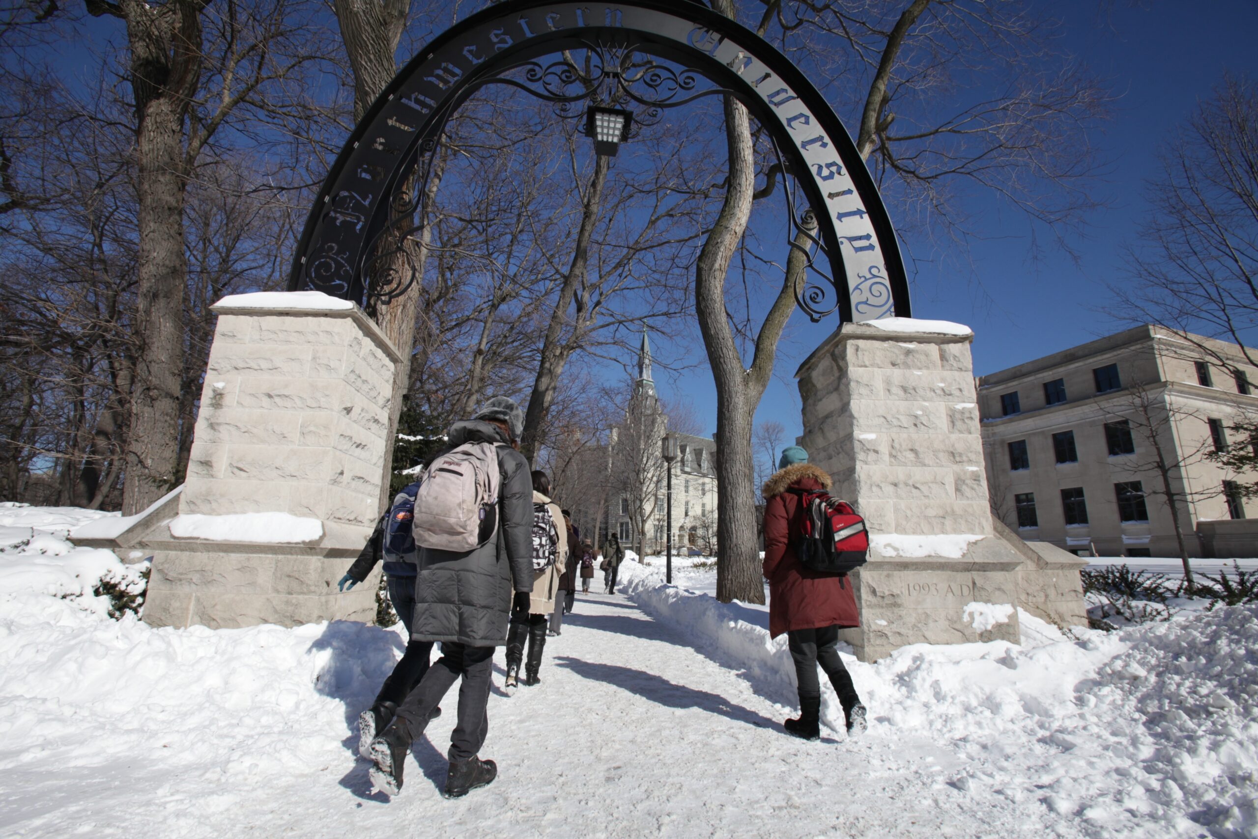 Students walk through an archway at Northwestern University's campus in Evanston, Ill.