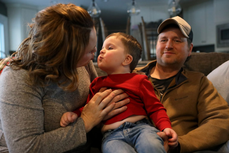 Brenna and Joel Siebold are seen with their son, Leo, 2, at their home