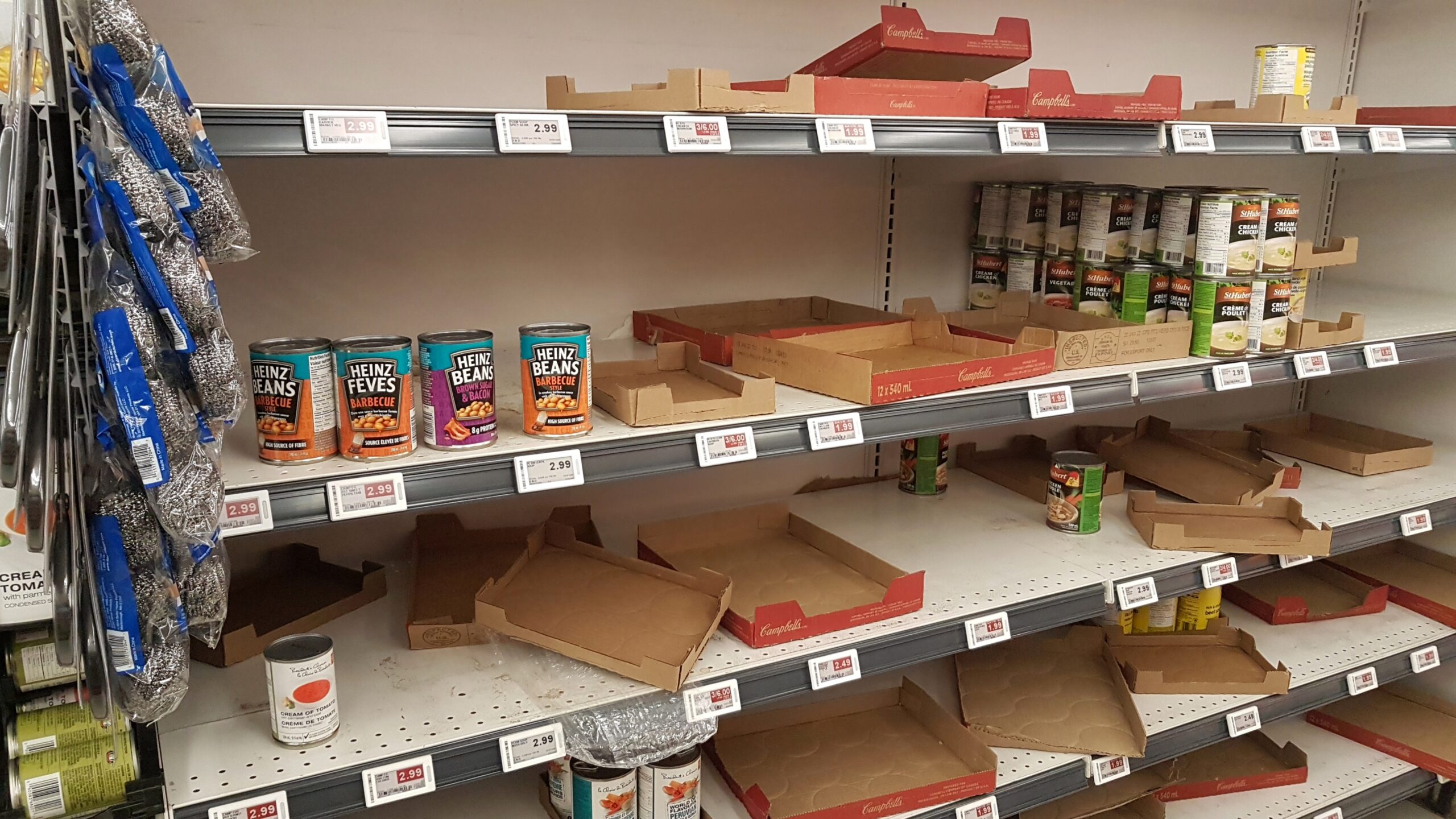 Mostly empty shelves of a supermarket