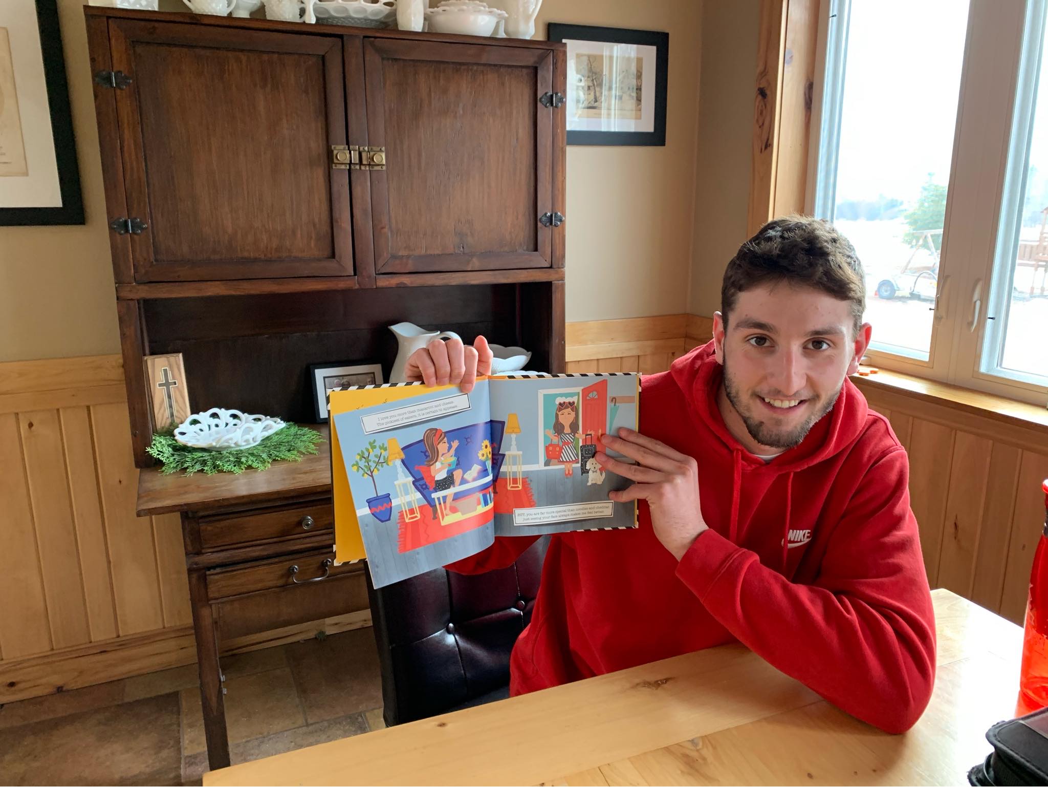 High school student Oscar Telschow with picture book for story time