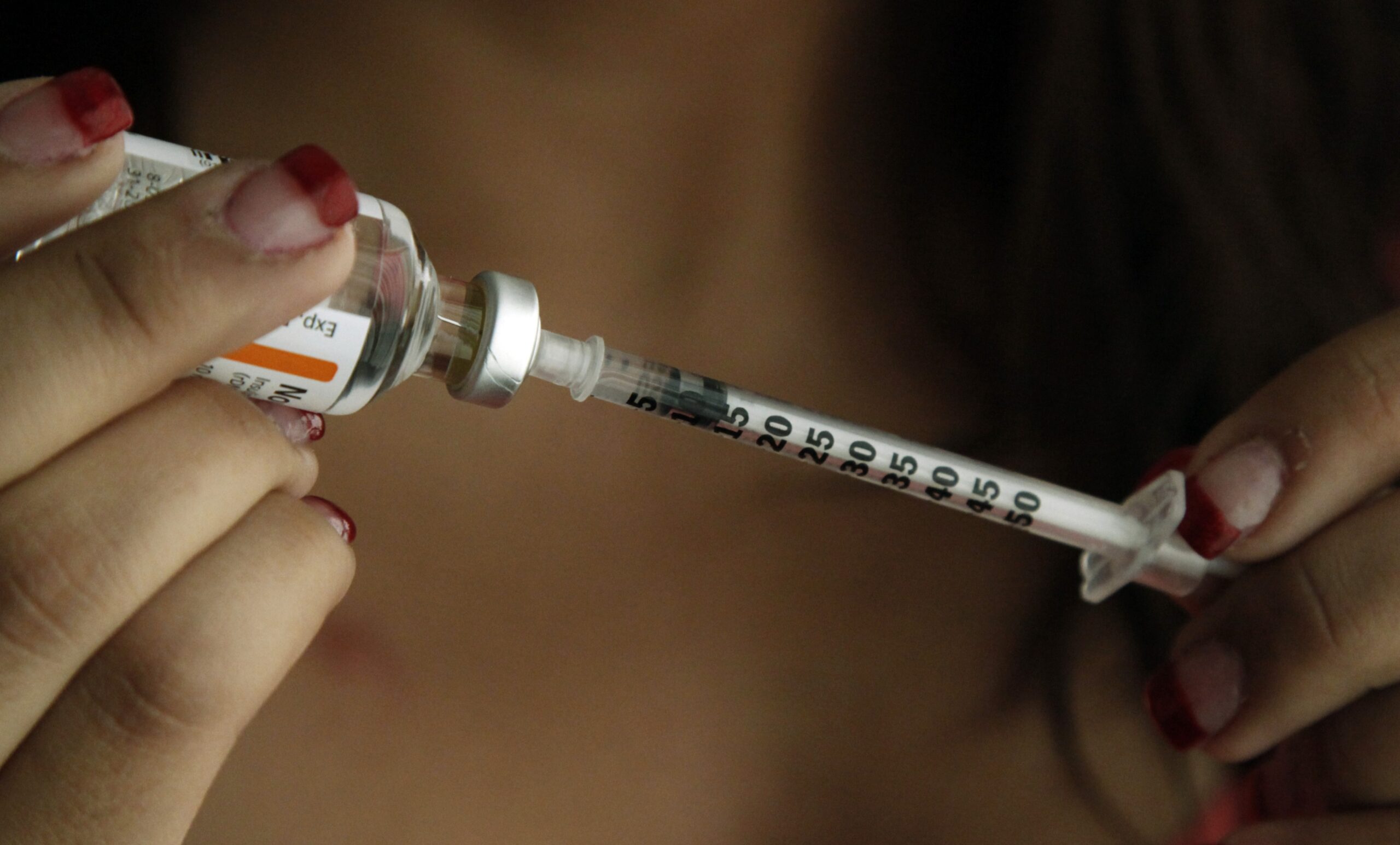insulin being put into a needle