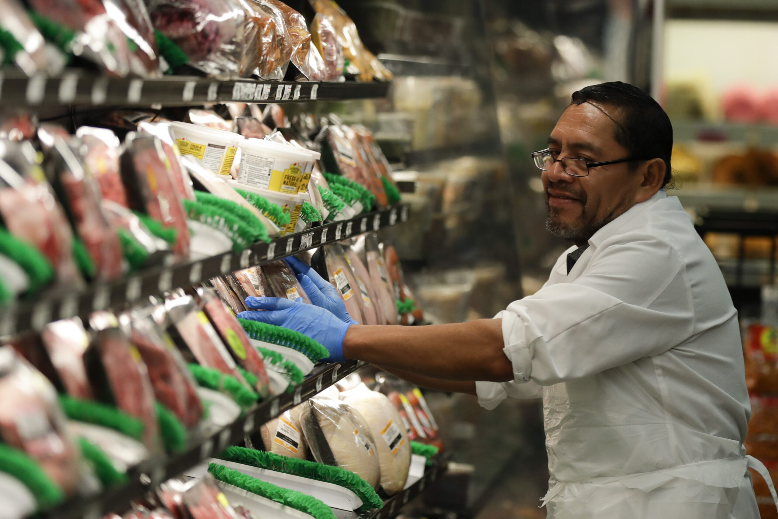 Jose Perez stocks meat wearing rubber gloves