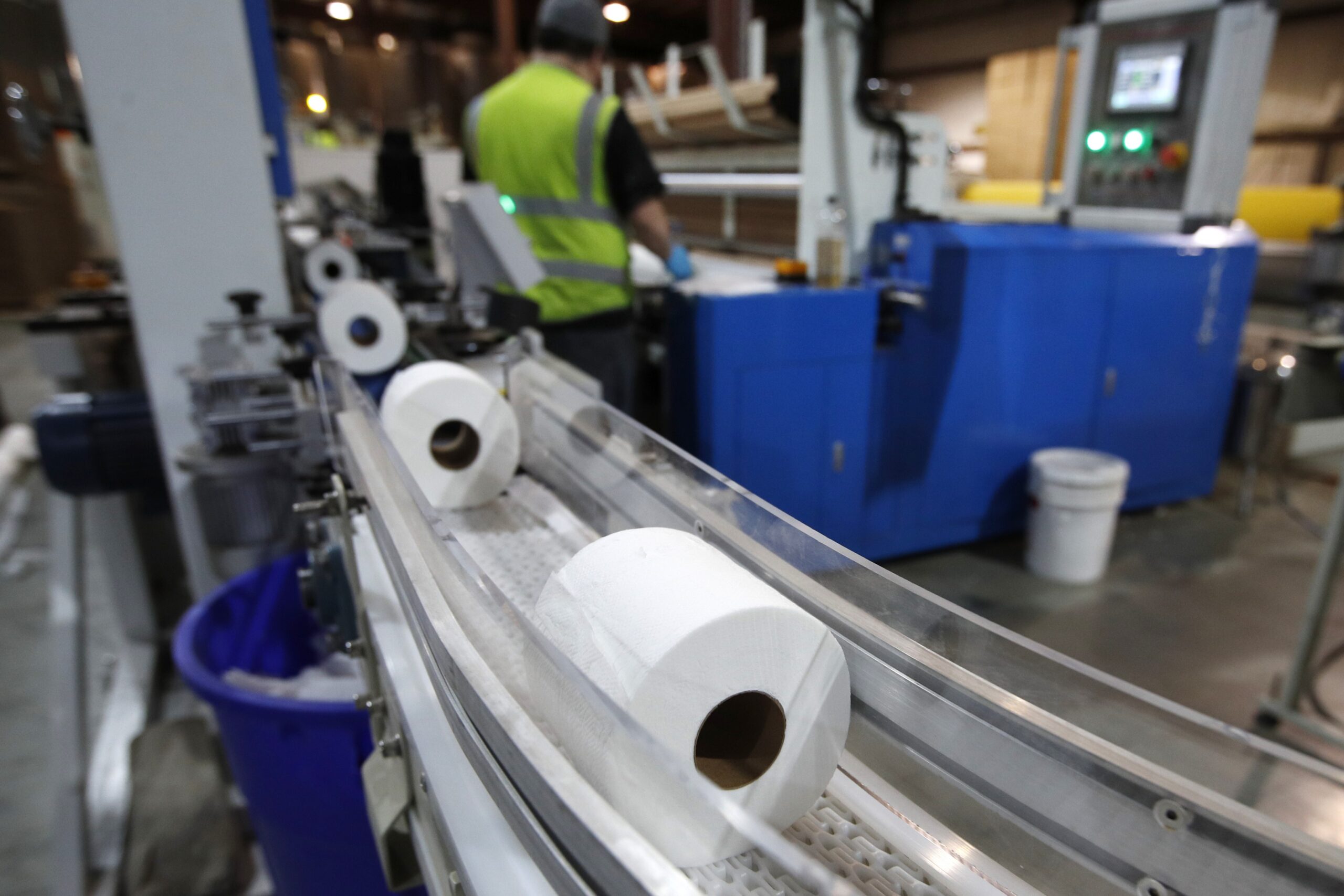 Toilet paper moves out from a cutting machine at the Tissue Plus factory