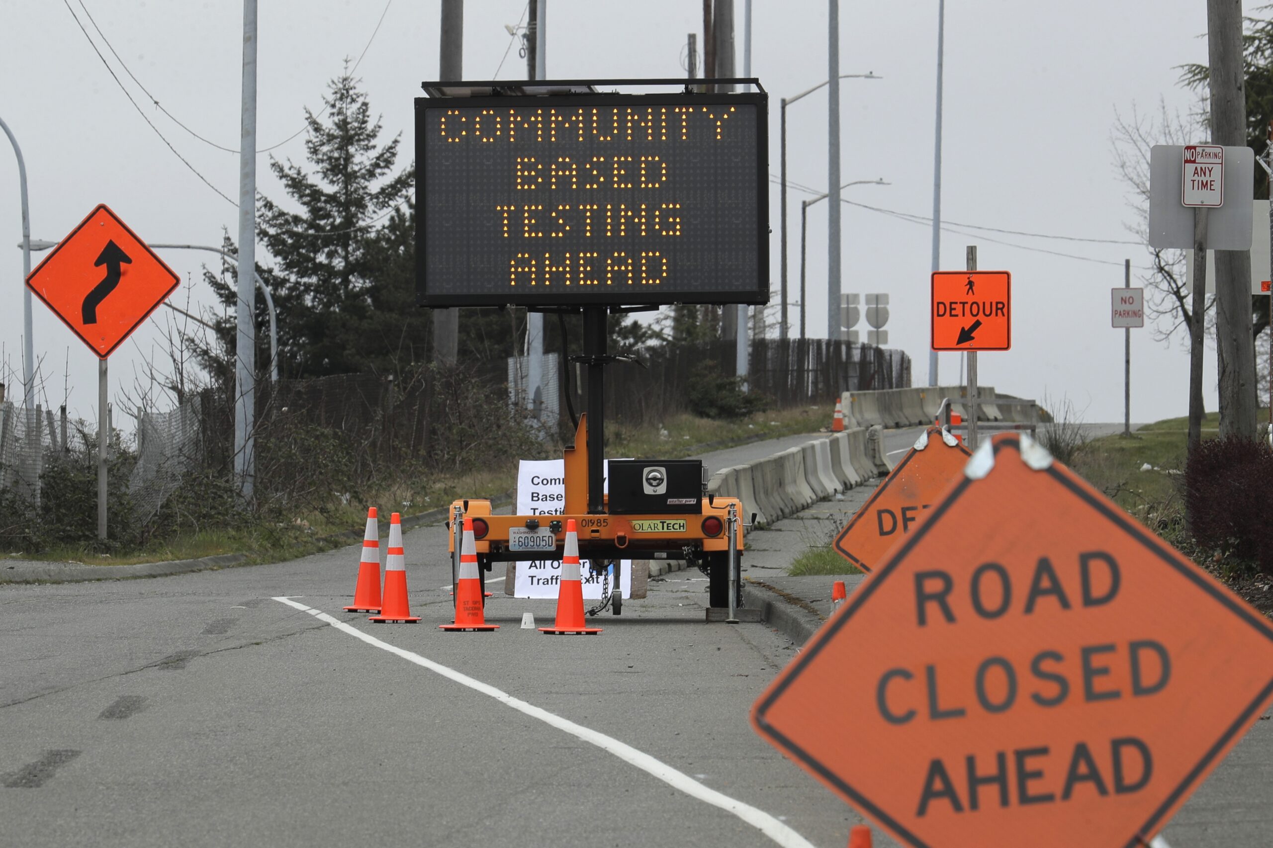 A sign directs vehicles toward a drive-up testing site at the Tacoma Dome in Tacoma, Wash