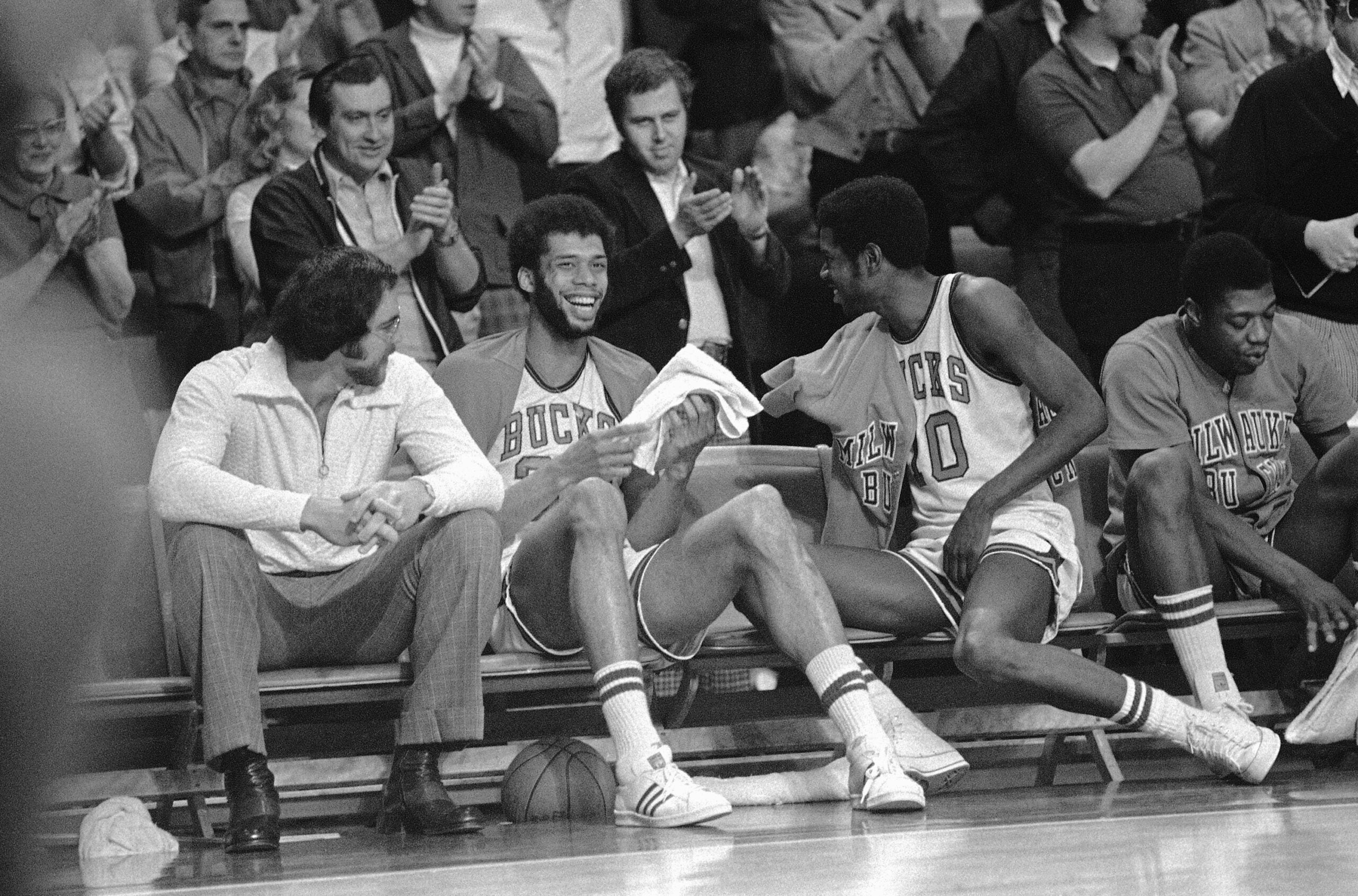 Bucks center Kareem Abdul-Jabbar laughs as he sits on bench