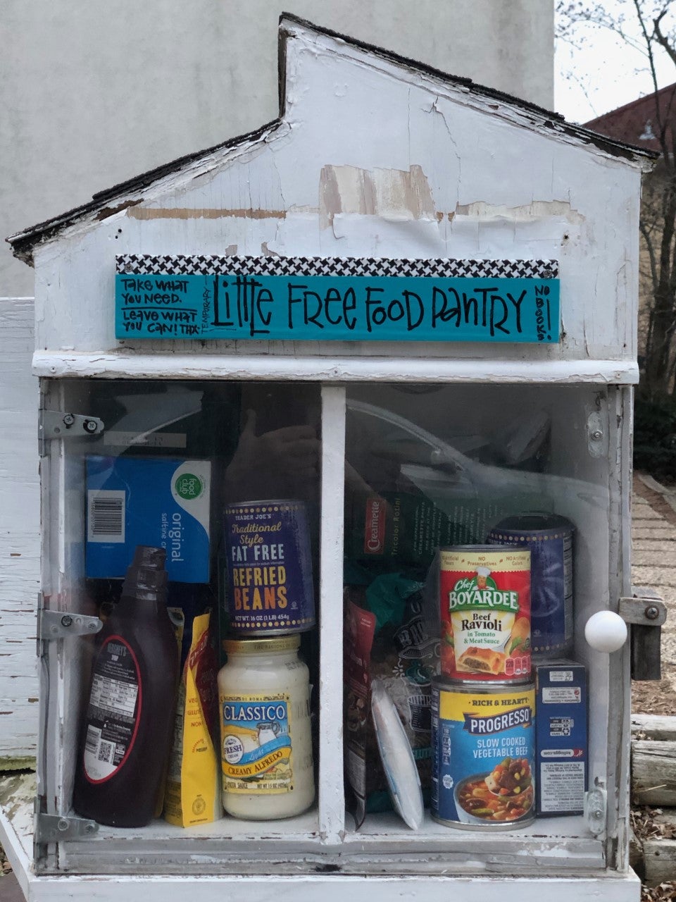 A little house-shaped box with a sign that says