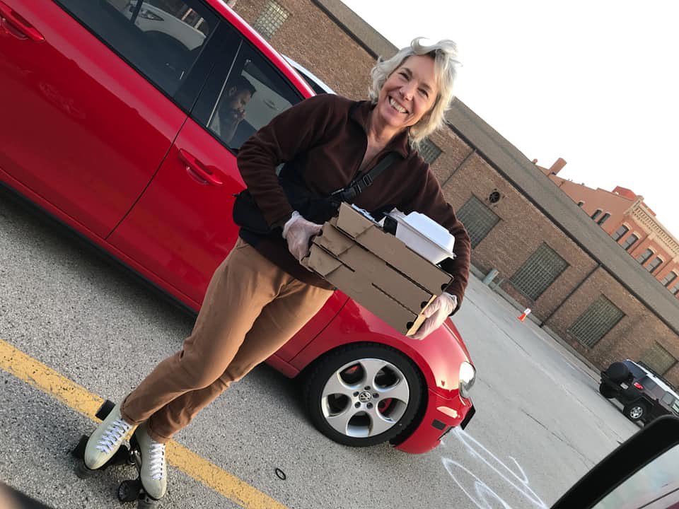 An Il Ritrovo staff members delivers pizza on skates