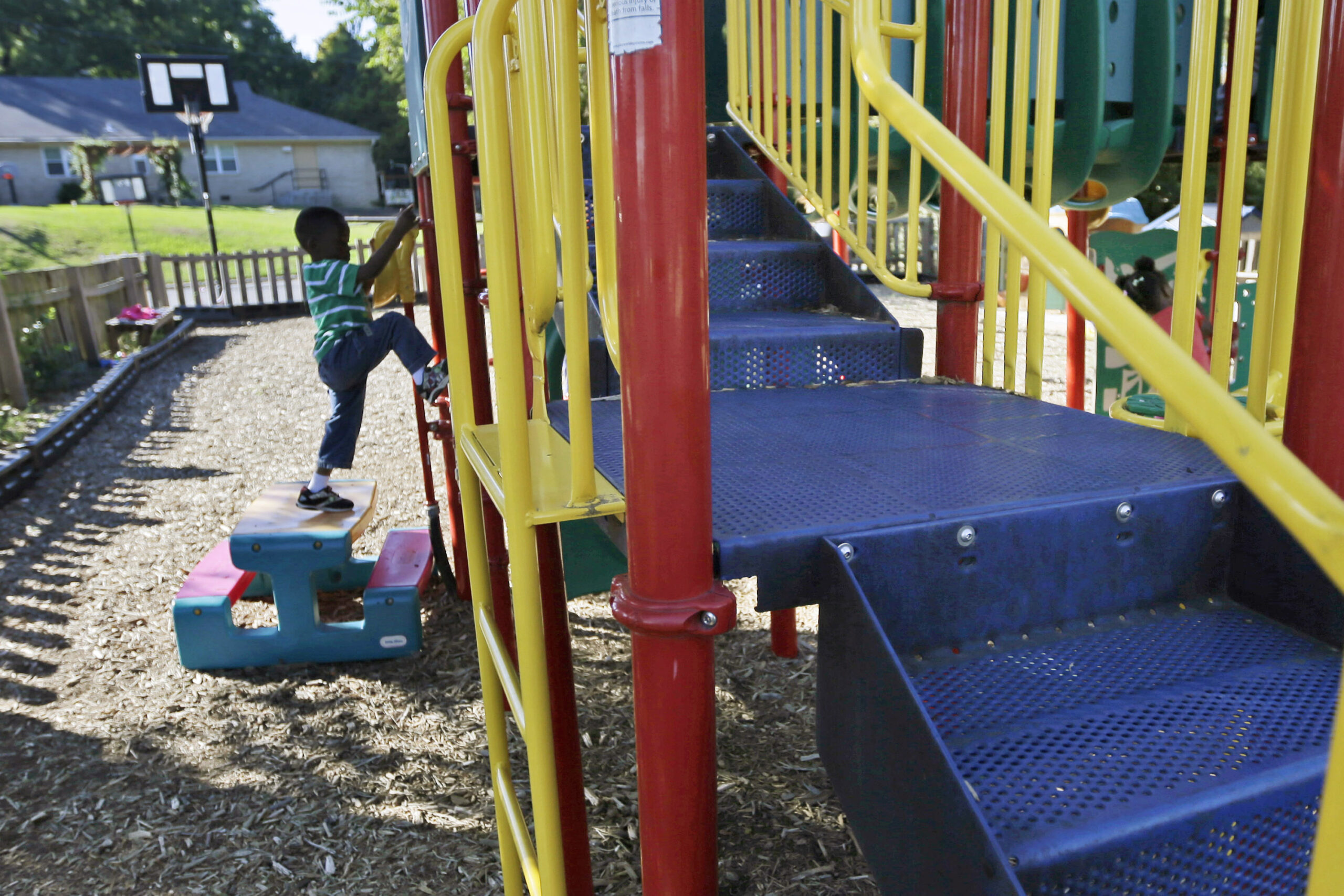 child playing on playground at child care facility