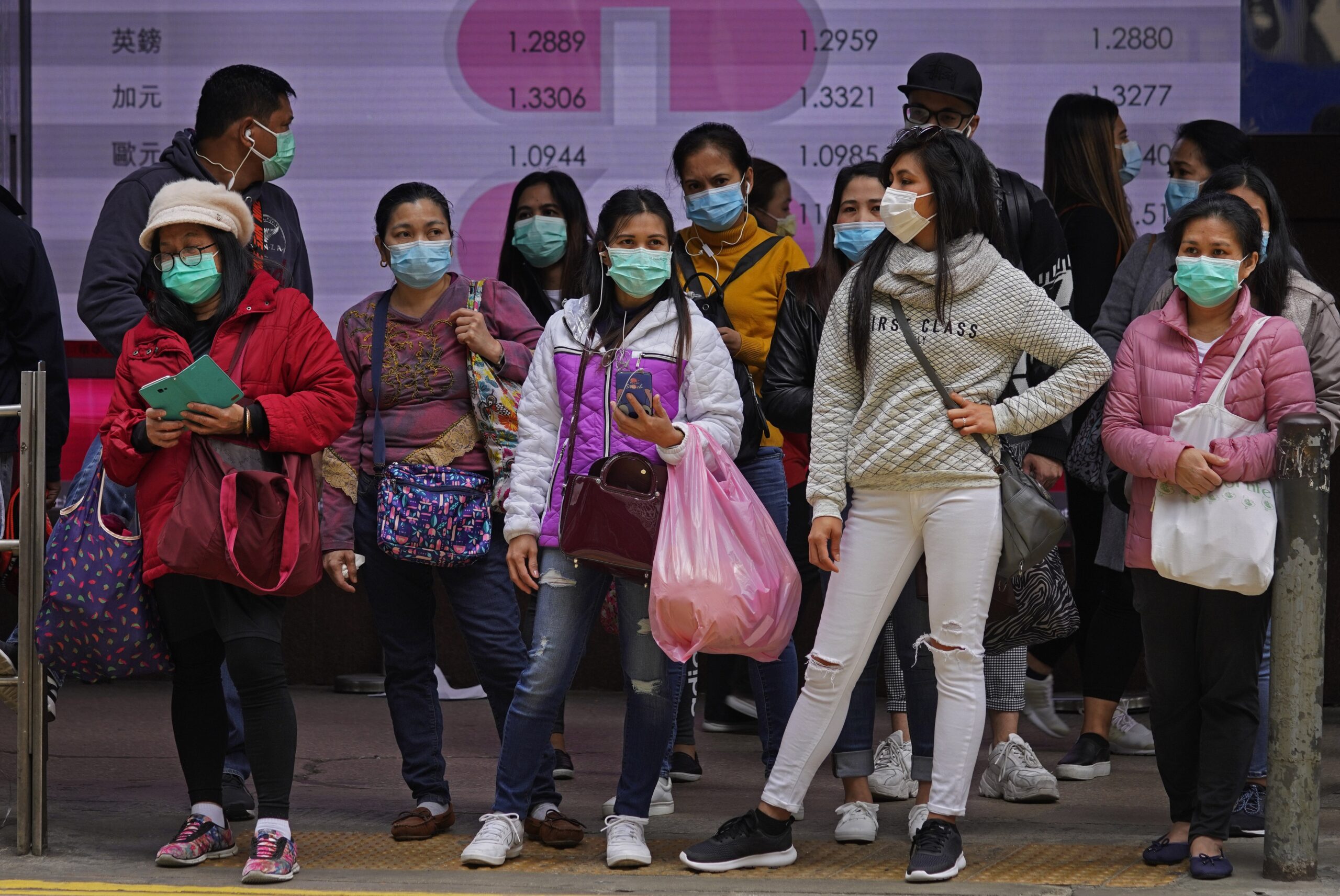 People wear protective face masks on a street corner in Hong Kong
