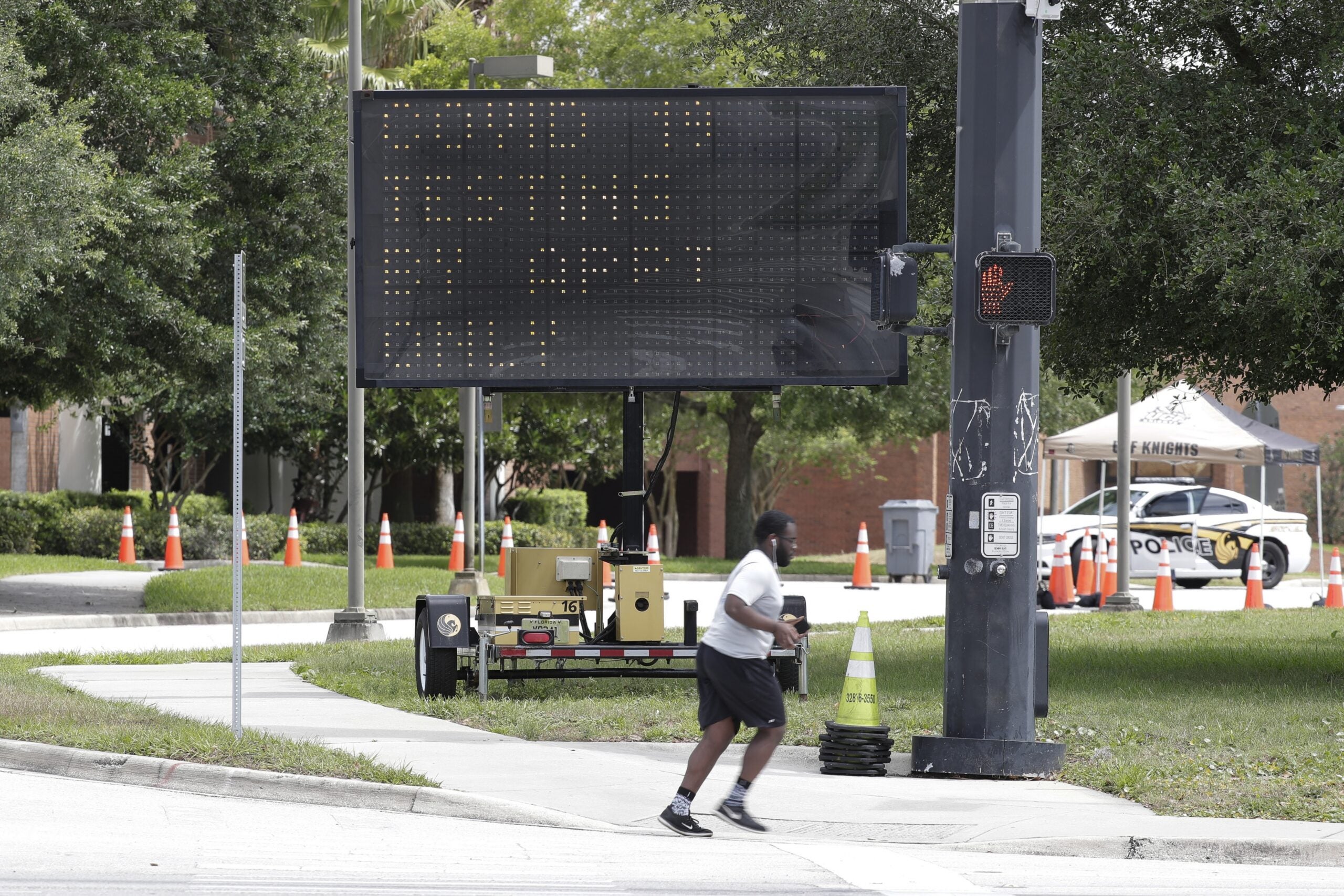 jogger runs past the entrance to a coronavirus mobile testing facility