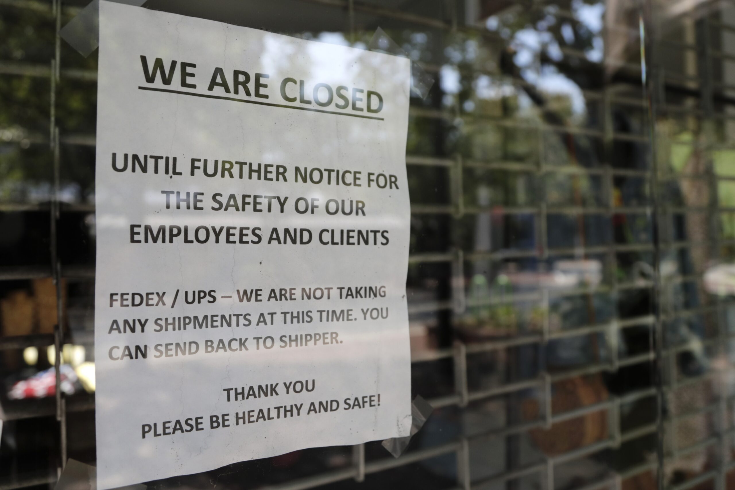 "Closed" sign posted on business door