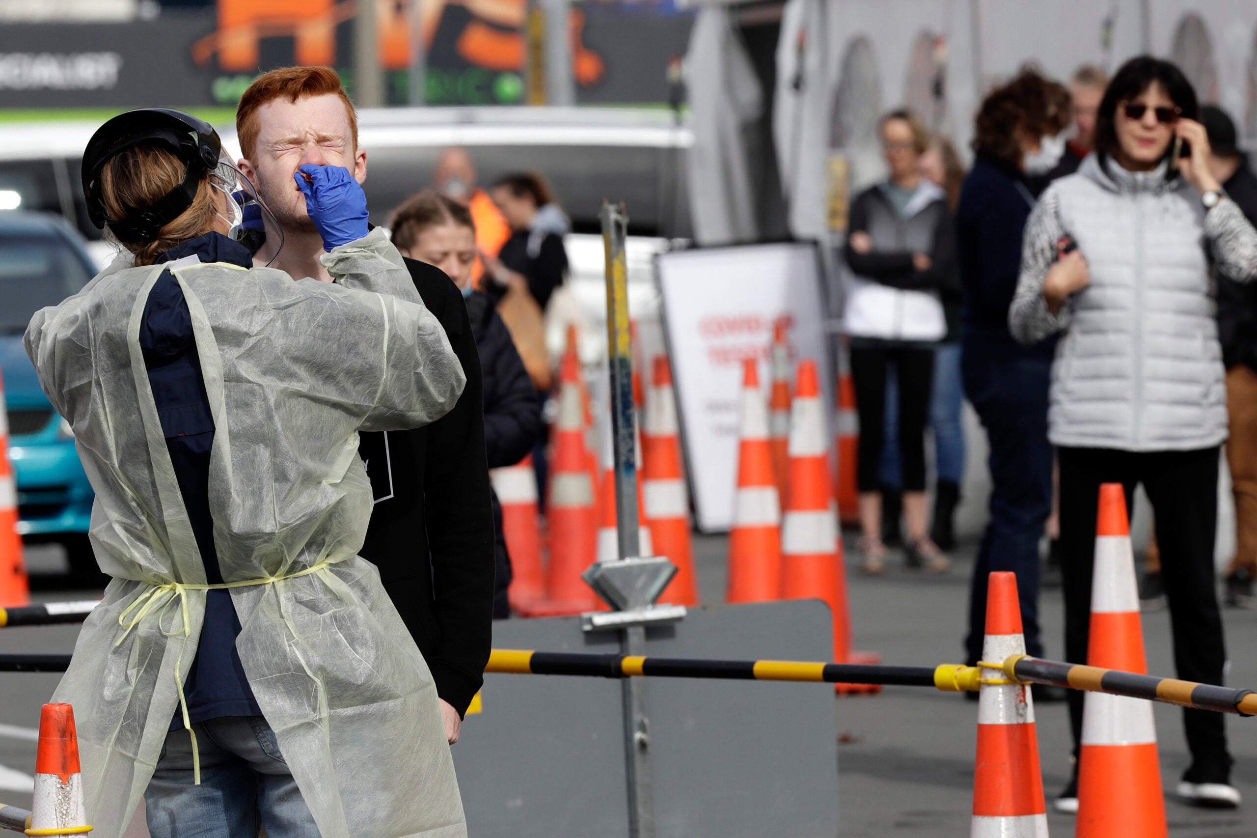 Medical staff test shoppers who volunteered at a pop-up community COVID-19 testing station