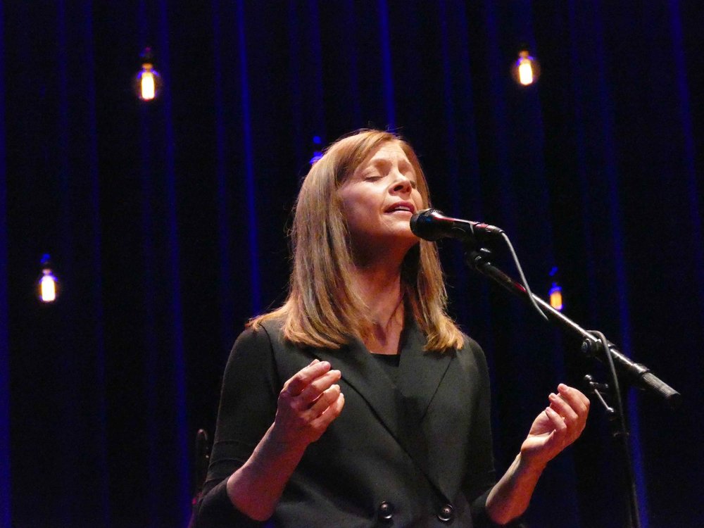 Carrie Newcomer singing during a live performance