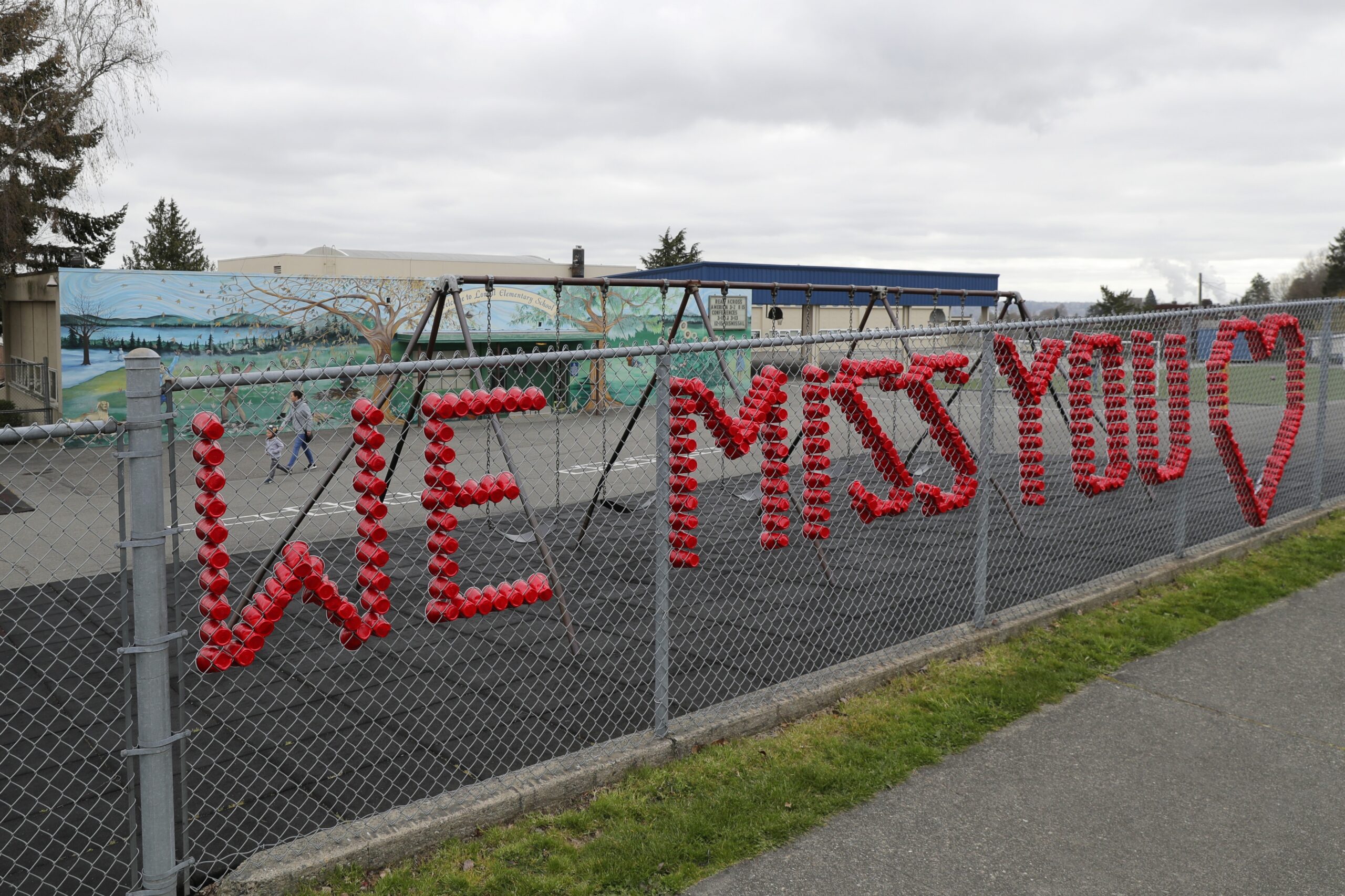 A sign reads "We Miss You" at Lowell Elementary School in Tacoma, Wash.