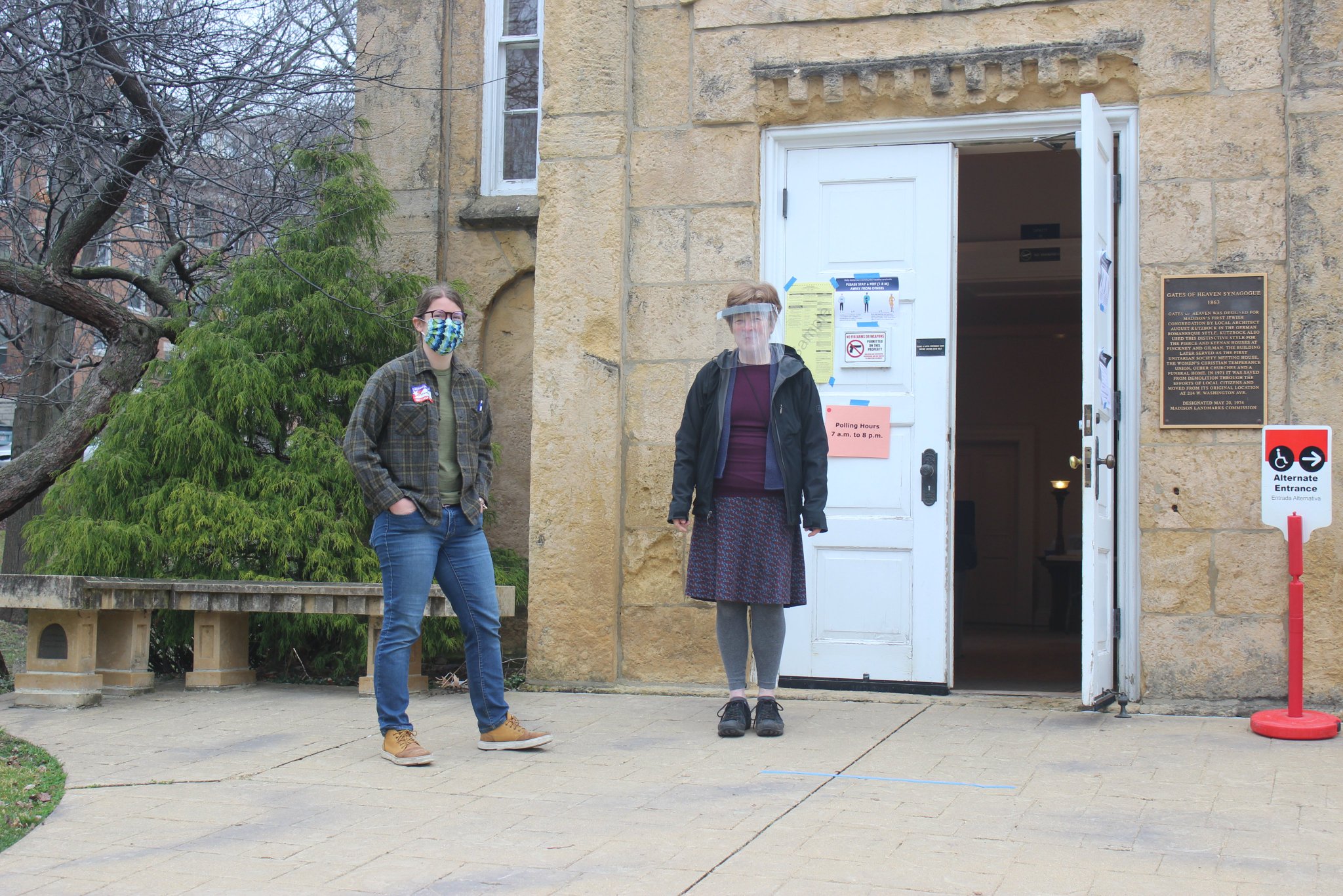 Poll workers wearing masks prepare for voters to arrive at Gates of Heaven