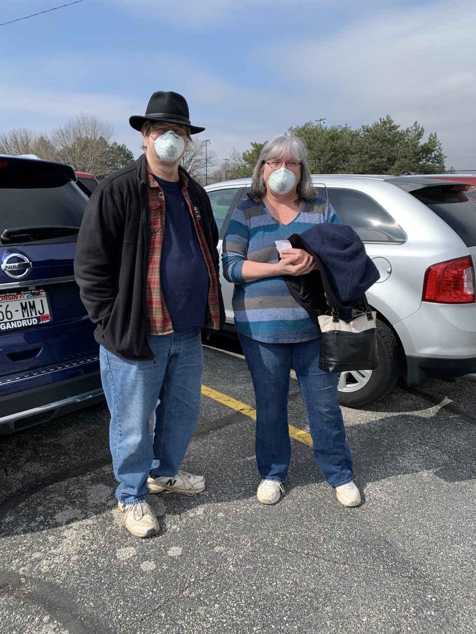 Beth Ferrier and her husband are pictured outside their polling place on April 7, 2020.