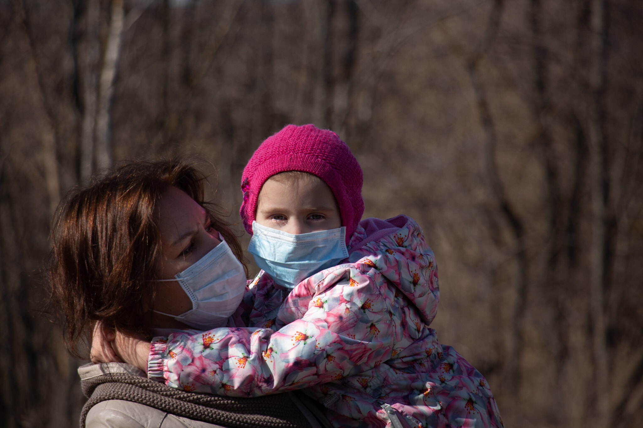 Woman and child wearing medical masks