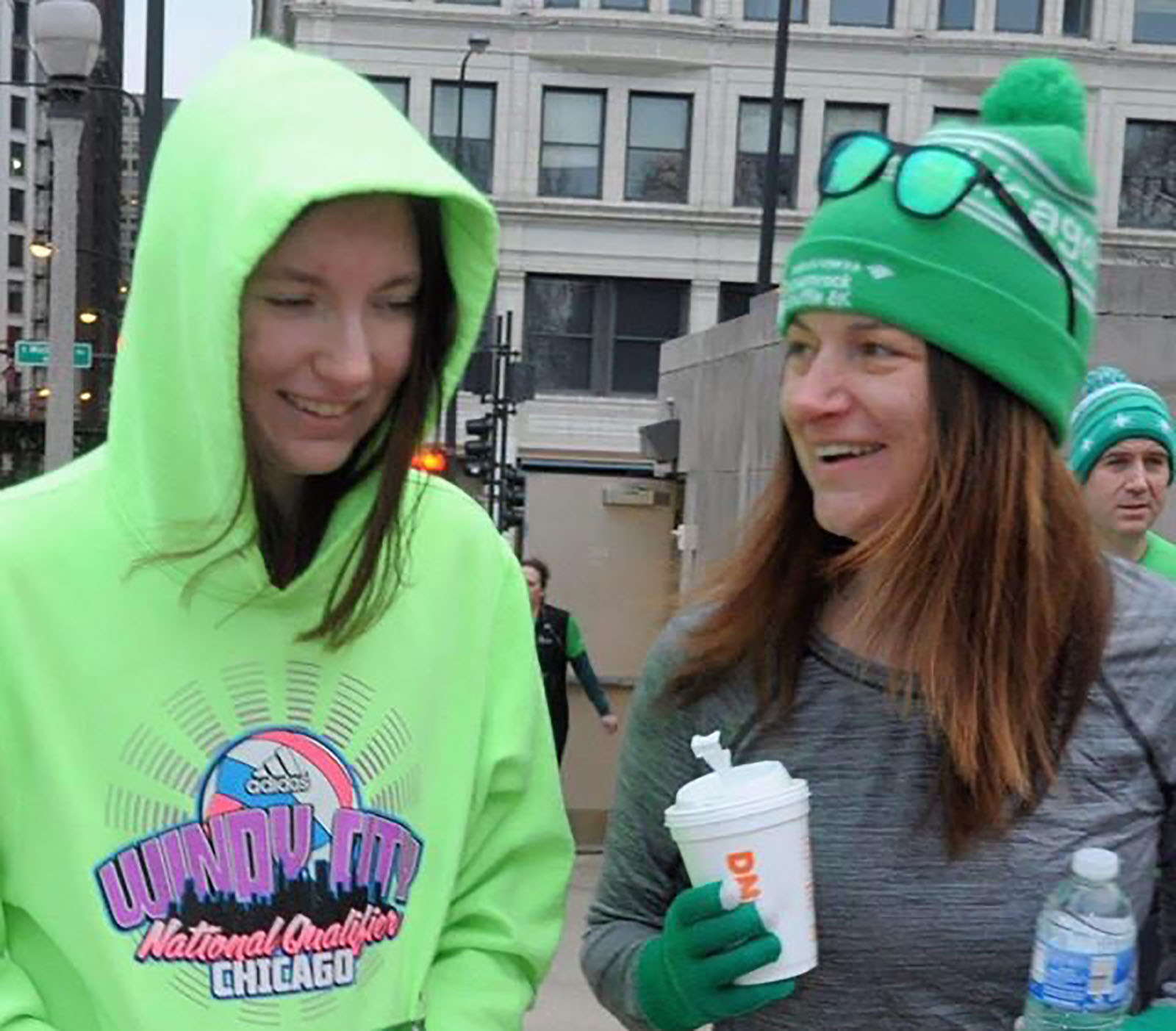 Lora Daley and her daughter, Claire, try to stay warm before the 2019 Shamrock Shuffle