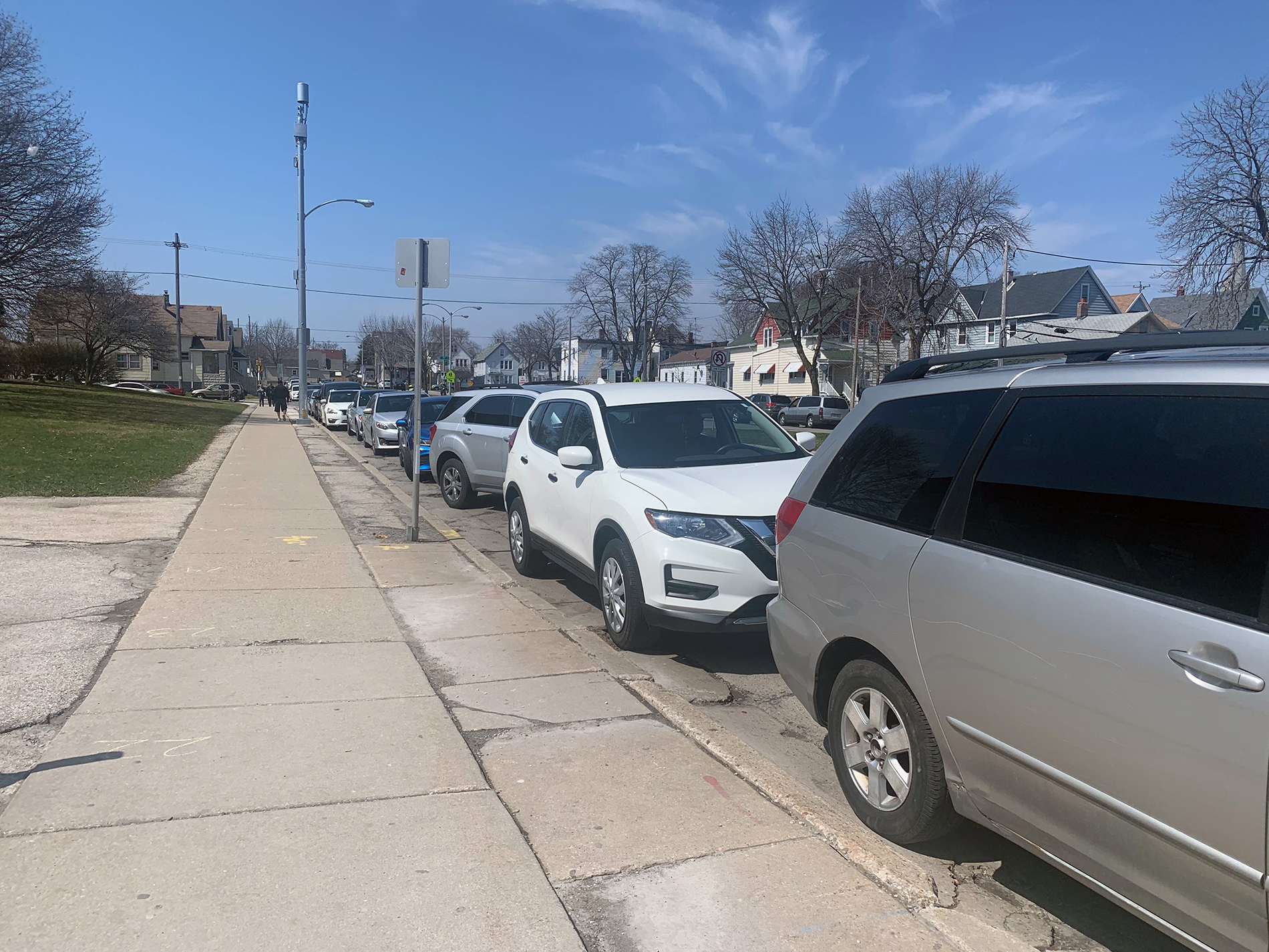 Cars line up to vote curbside at South Division High School in Milwaukee