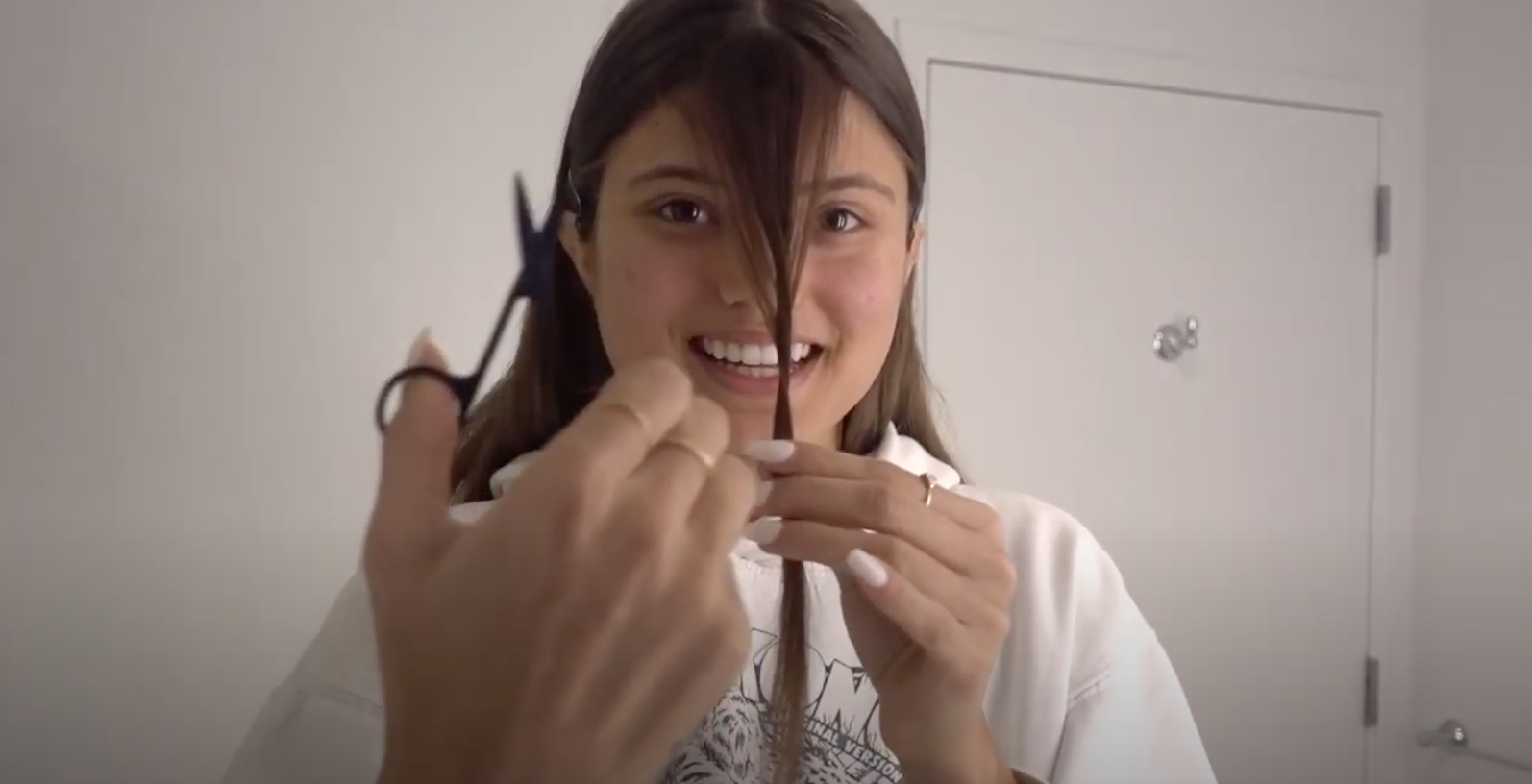A woman in quarantine cutting her own bangs