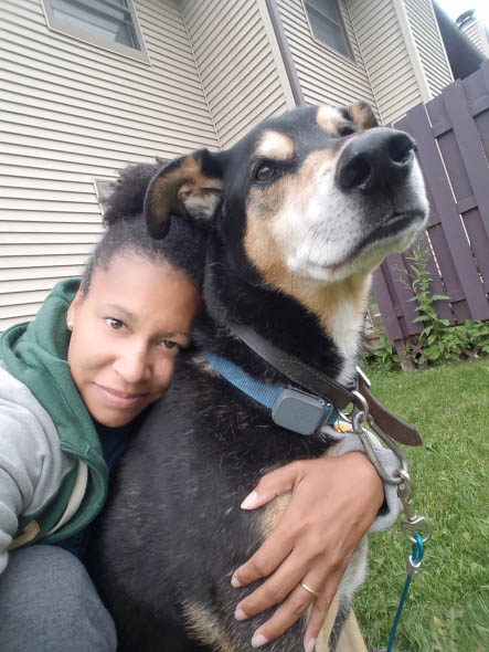 Shalicia Johnson cuddles her pet dog, Arrow
