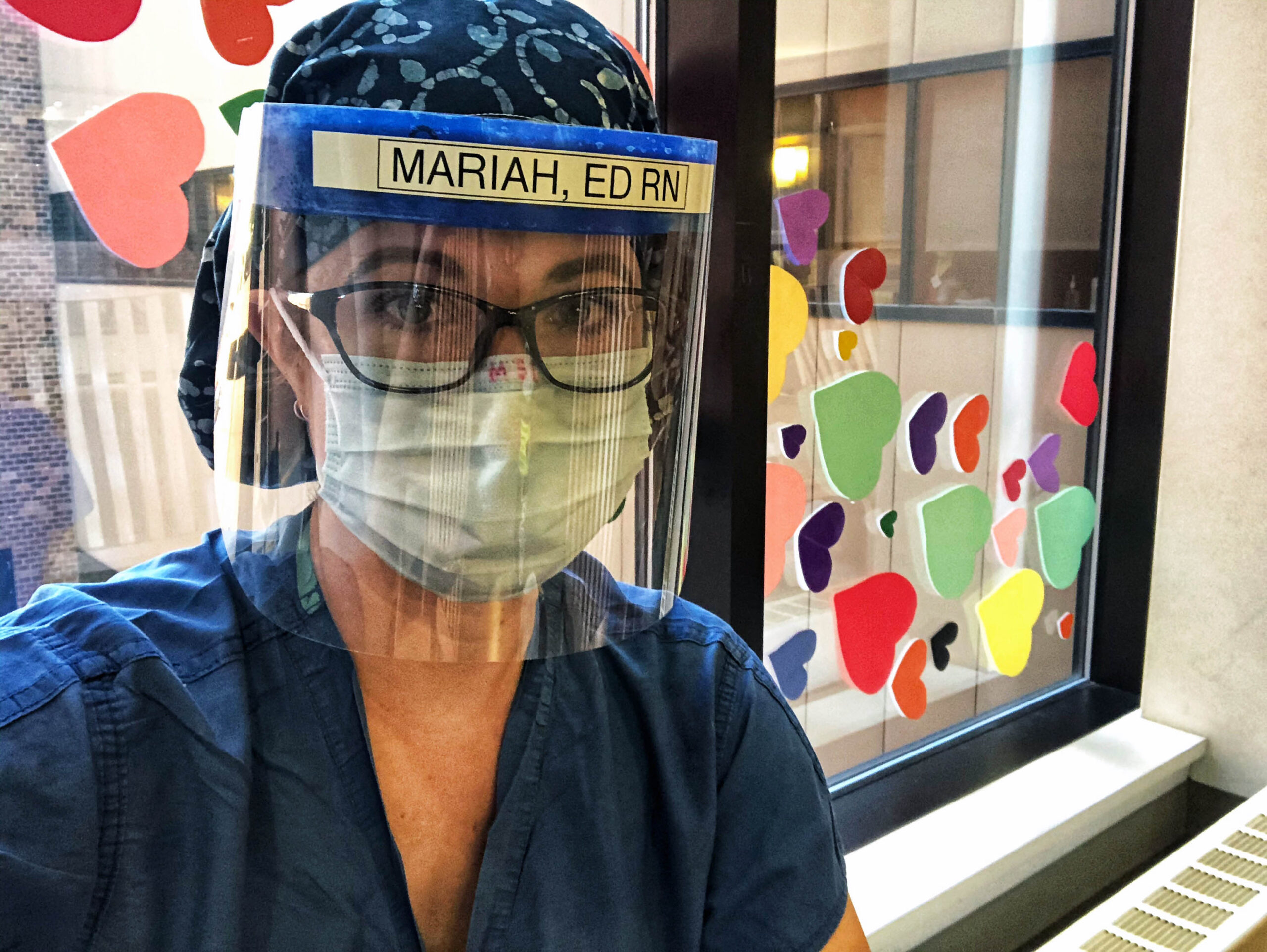 Mariah Clark, an emergency room nurse who has worked at University of Wisconsin Hospital for 12 years, wears personal protective equipment