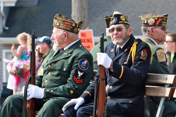 Two veterans sit on a bench