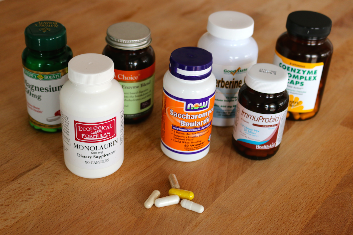 A variety of probiotic supplements sit on a counter.