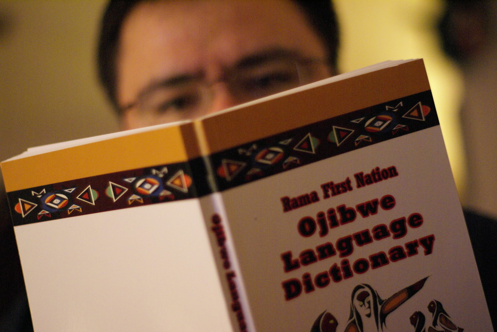 Man reading Ojibwe dictionary.