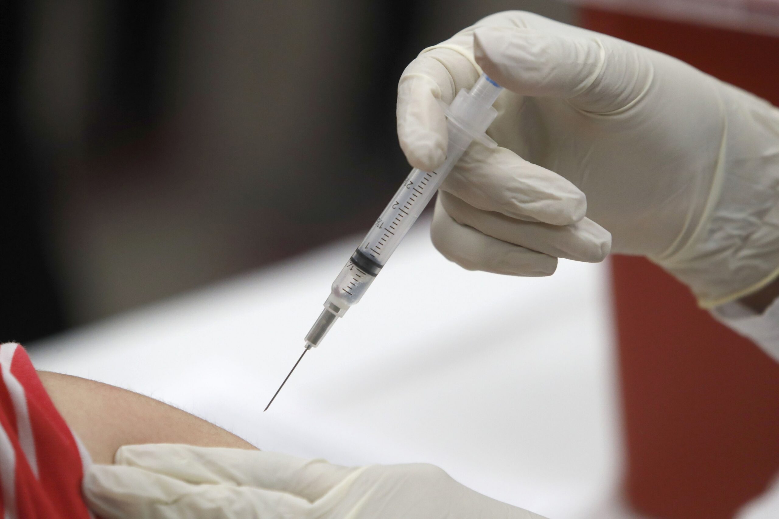 A health professional administers a flu vaccine