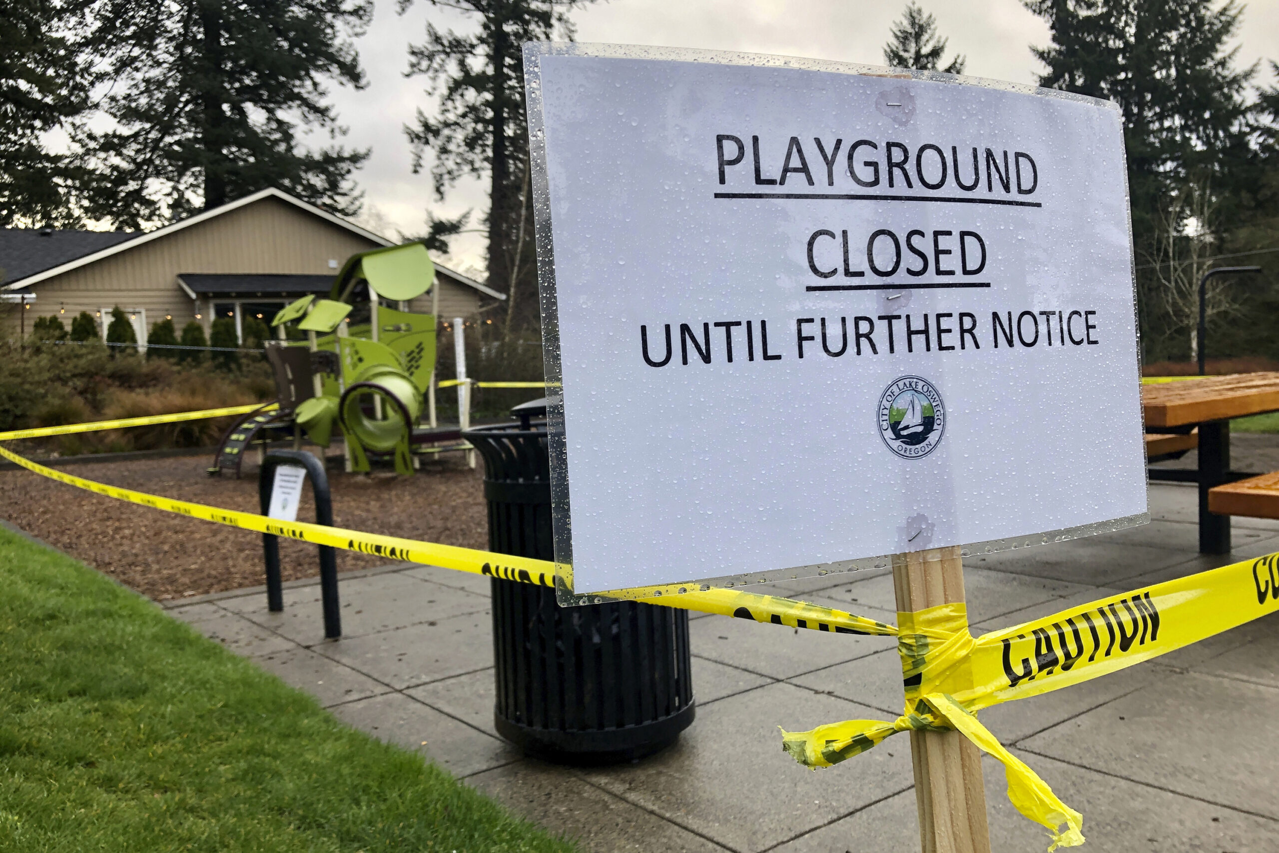Police caution tape surrounds a playground in Lake Oswego, Ore.