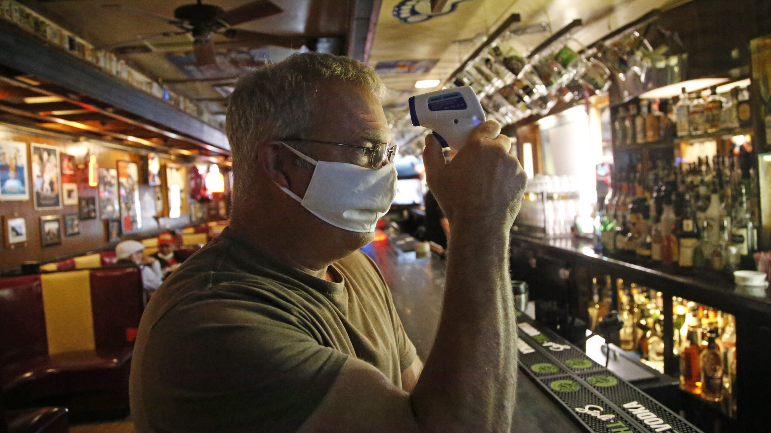 Cheers to You bar owner Bob Brown tests a thermometer at his bar