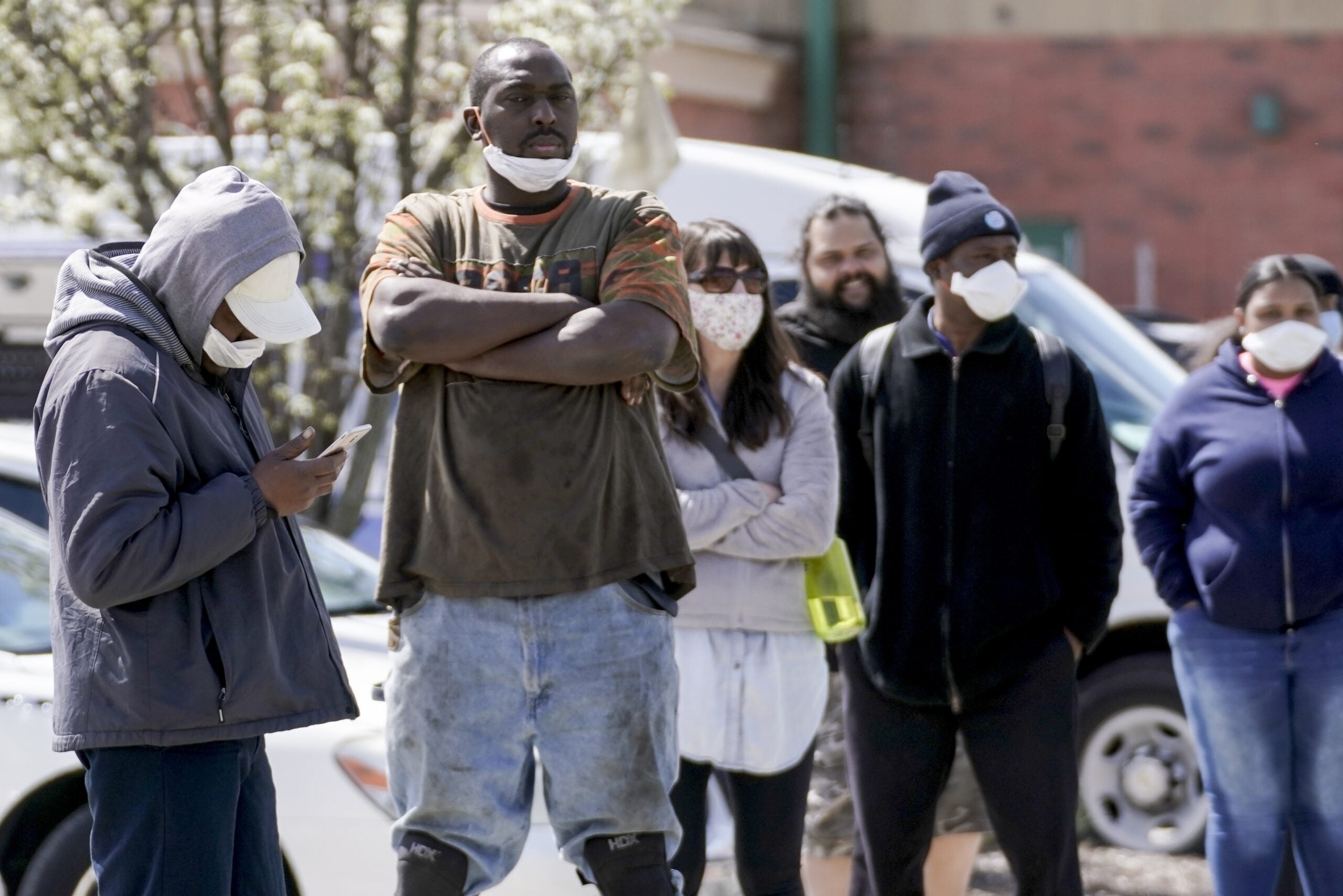 People line up for a COVID-19 test in a parking lot in Milwaukee