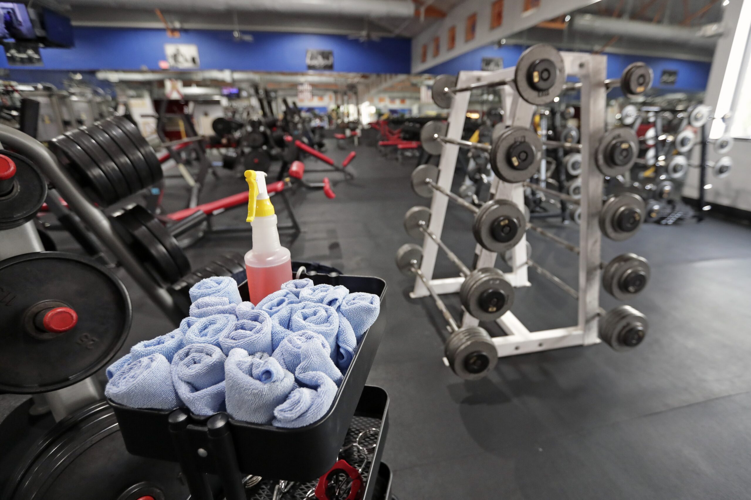 A Florida gym has towels and sanitizing spray readily available to visitors.