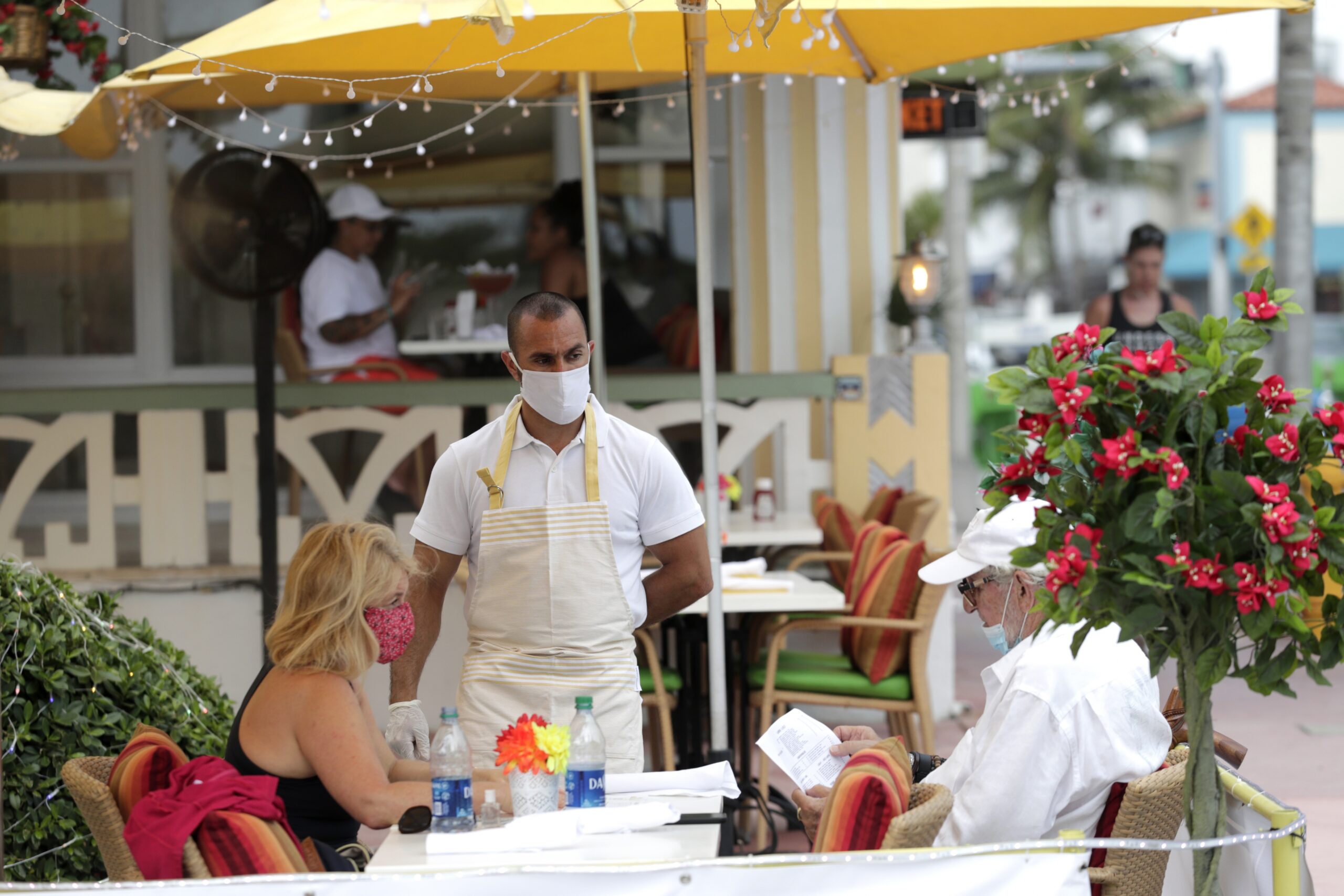 People sit outside at a restaurant during the coronavirus pandemic