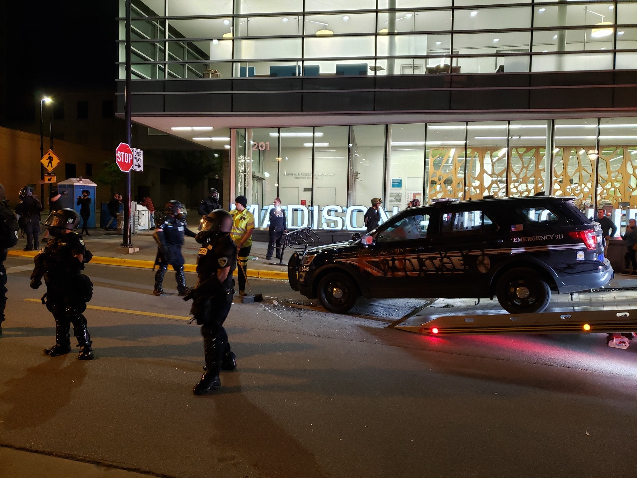 A tow truck is removing a police car that was vandalized in downtown Madison Saturday night.