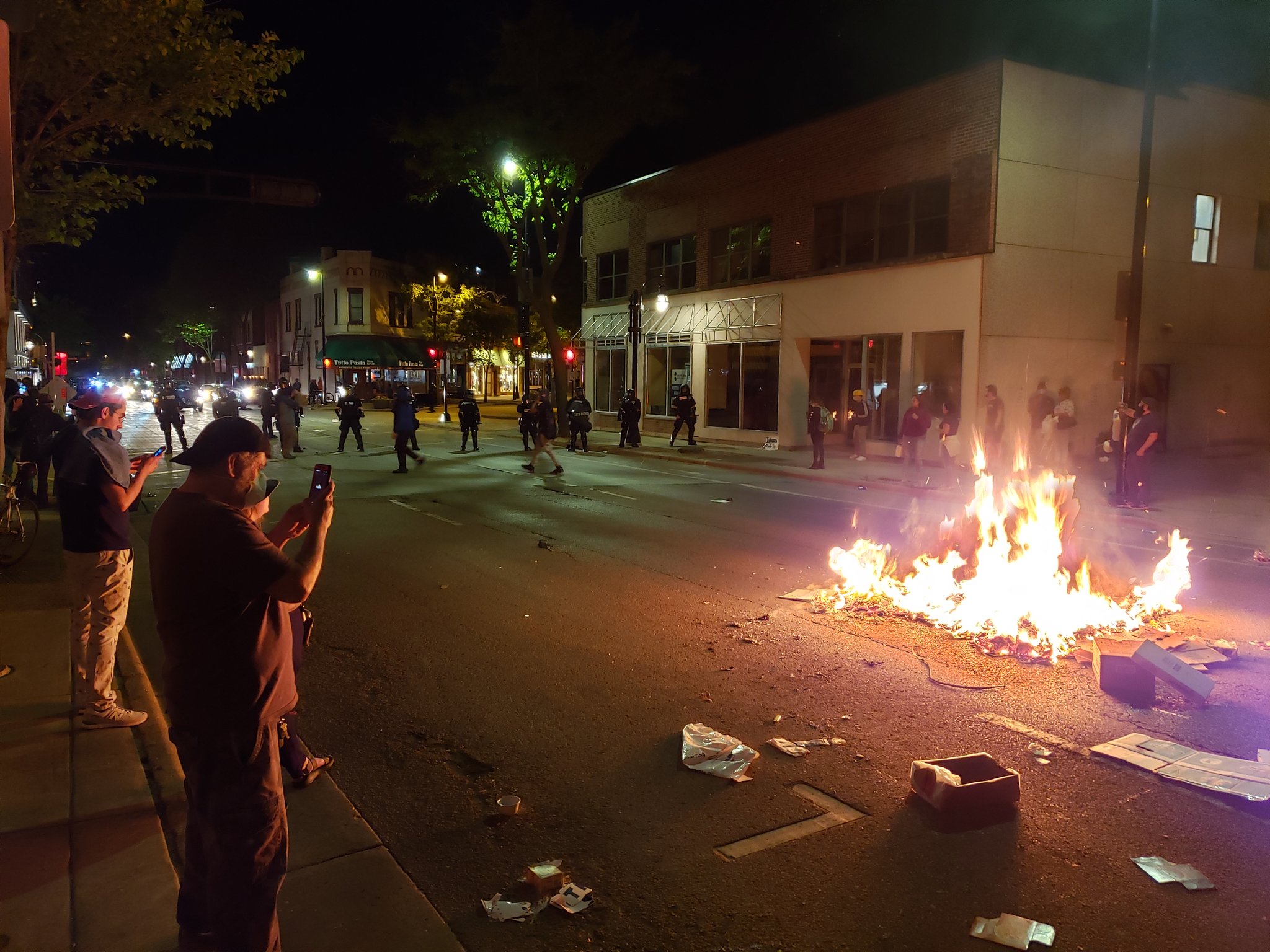 A crowd backed off to let Madison firefighters put out the trash fire in the middle of Johnson Street in downtown Madison on Saturday night.