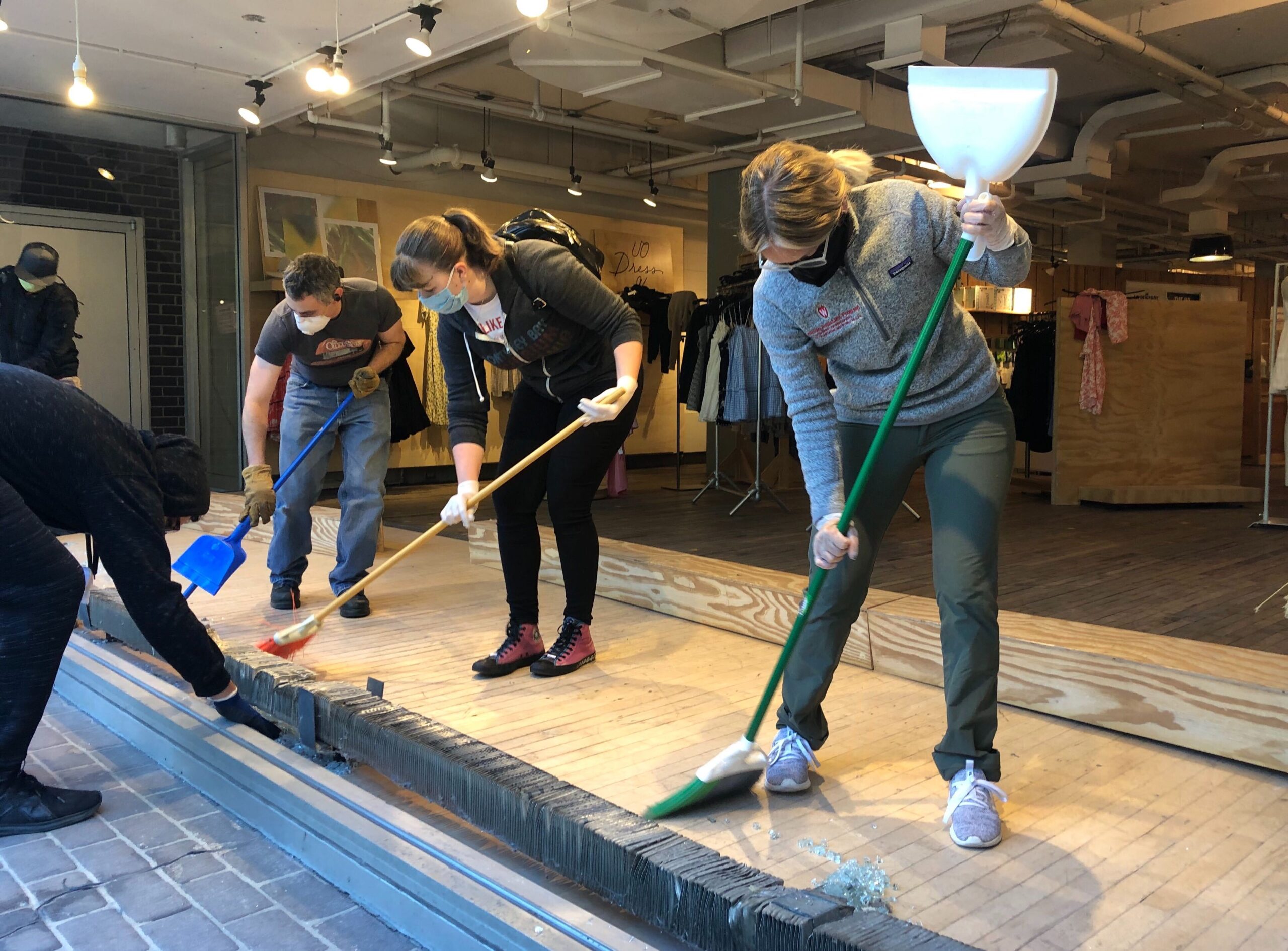 Volunteers work to clean up Urban Outfitters