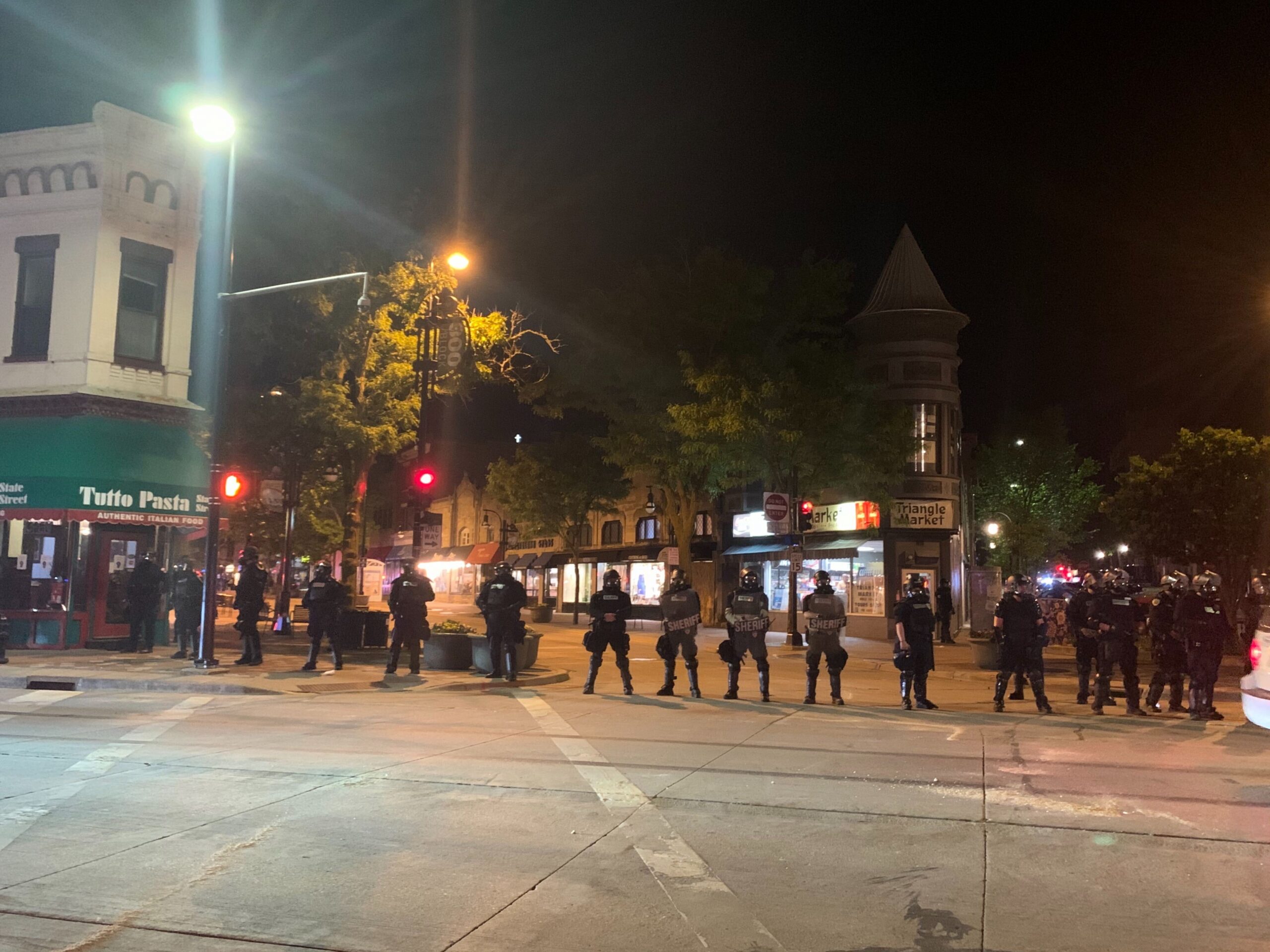 Police in riot gear block State Street in downtown Madison on Saturday night.