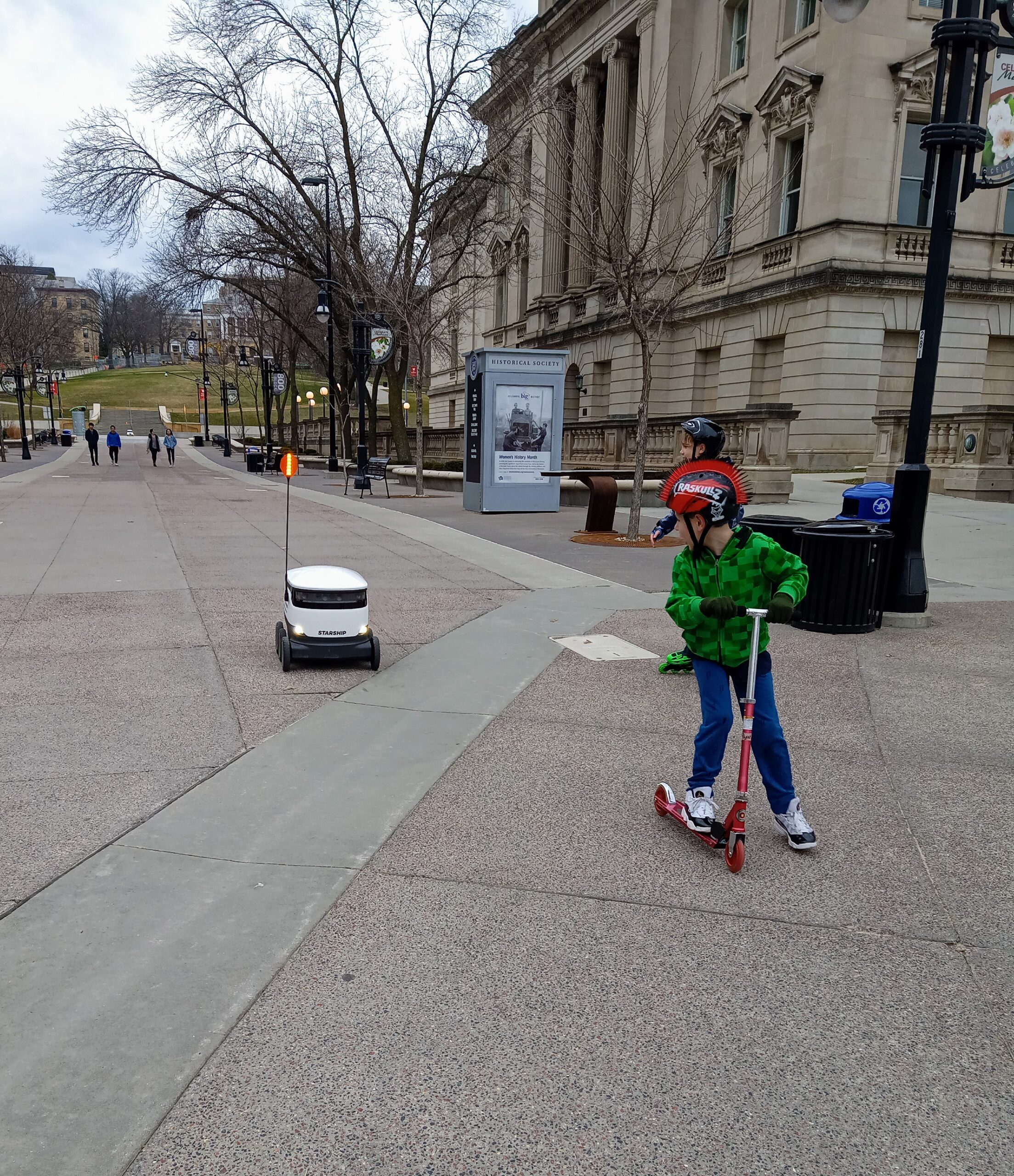Anna Mullen took her son, Ryan, to see the food delivery robots near the UW-Madison library during the second week of Safer at Home.