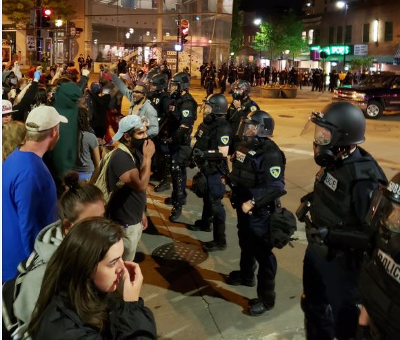 Protesters face off against police near State Street in downtown Madison on Saturday night.
